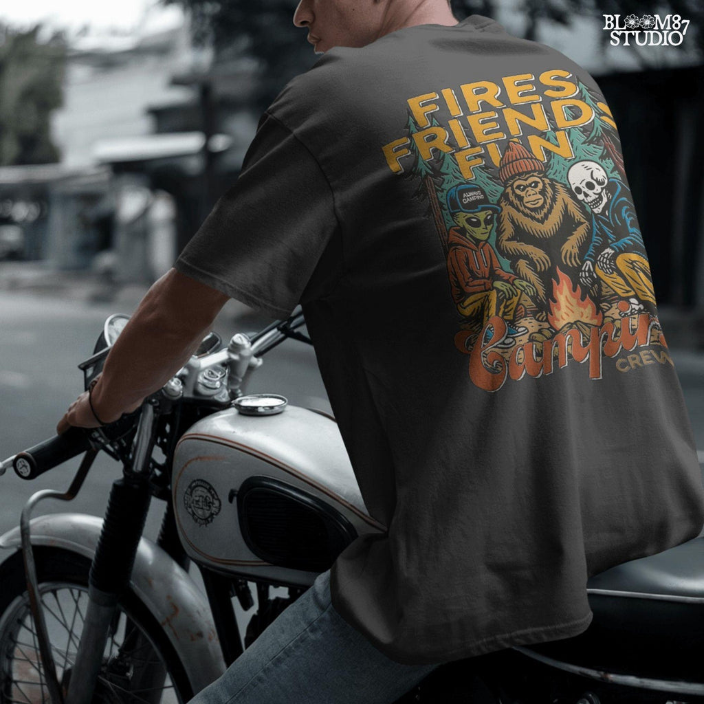 Funny cartoon-style illustration of an alien, bigfoot, and skeleton sitting around a campfire with the text “Fires. Friends. Fun. Camping Crew,” ideal for camping humor designs.