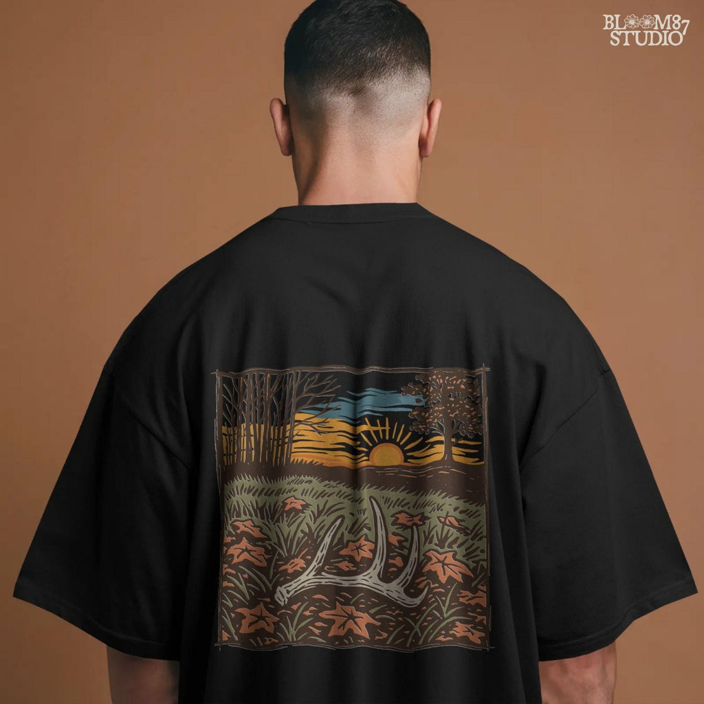 A rustic illustration of a whitetail antler lying in a fall field with orange leaves and a vibrant sunset sky in the background, PNG format for sublimation.