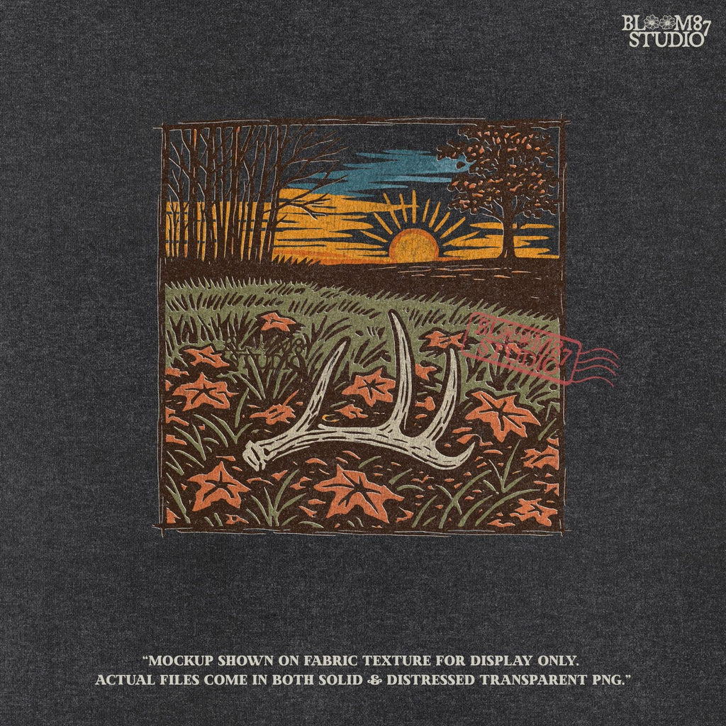 A rustic illustration of a whitetail antler lying in a fall field with orange leaves and a vibrant sunset sky in the background, PNG format for sublimation.