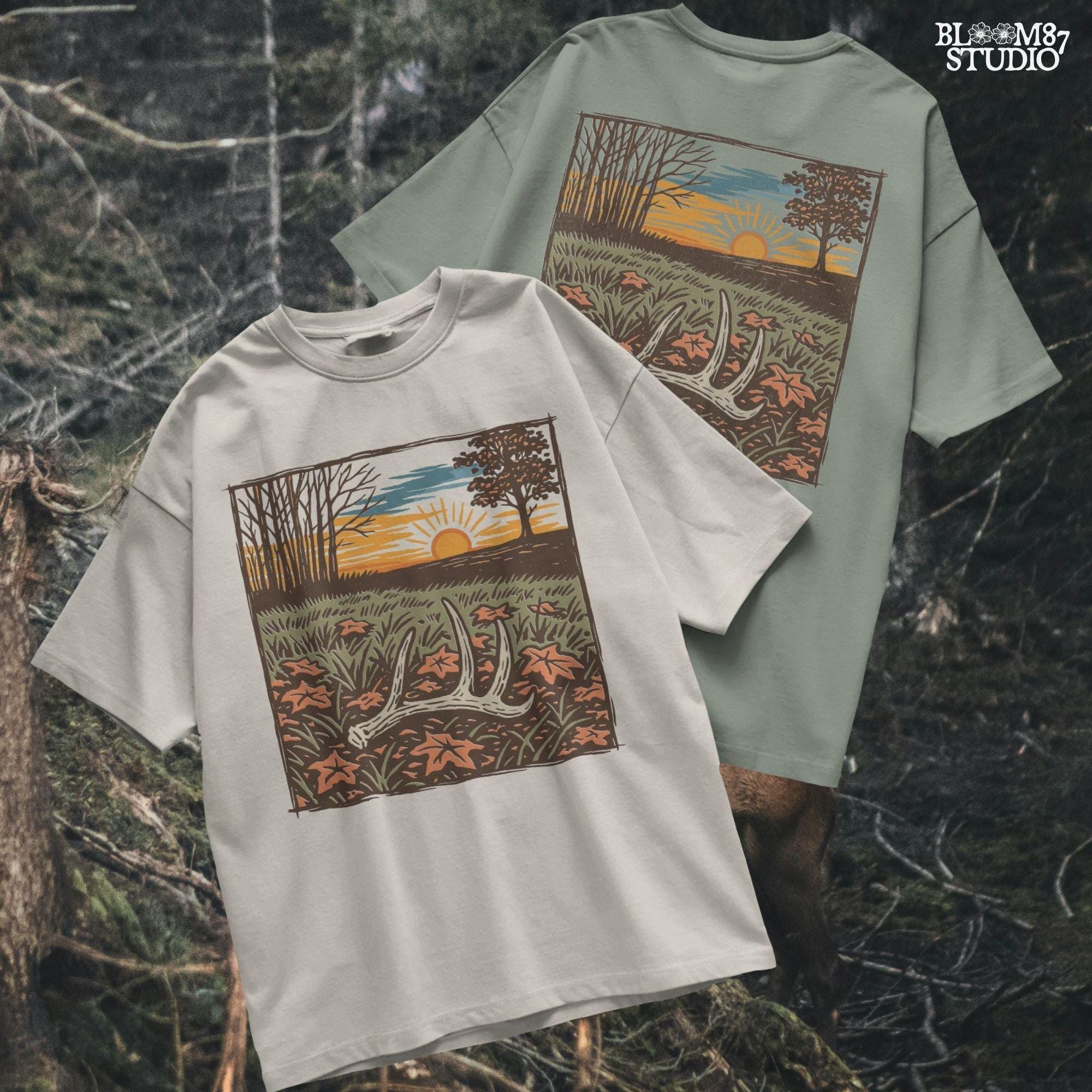 A rustic illustration of a whitetail antler lying in a fall field with orange leaves and a vibrant sunset sky in the background, PNG format for sublimation.