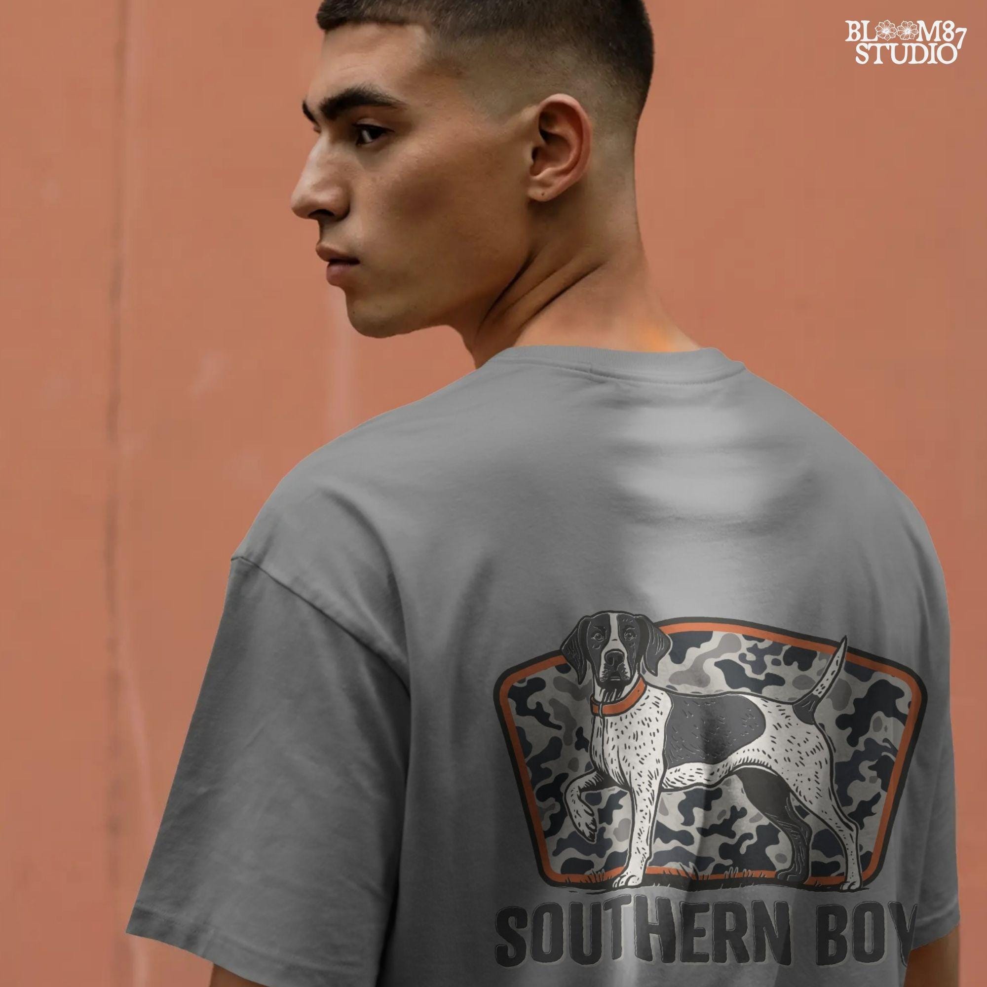 Illustration of a black and white pointer hunting dog standing in front of a gray camo background with the words “Southern Boy” beneath in bold rustic font.