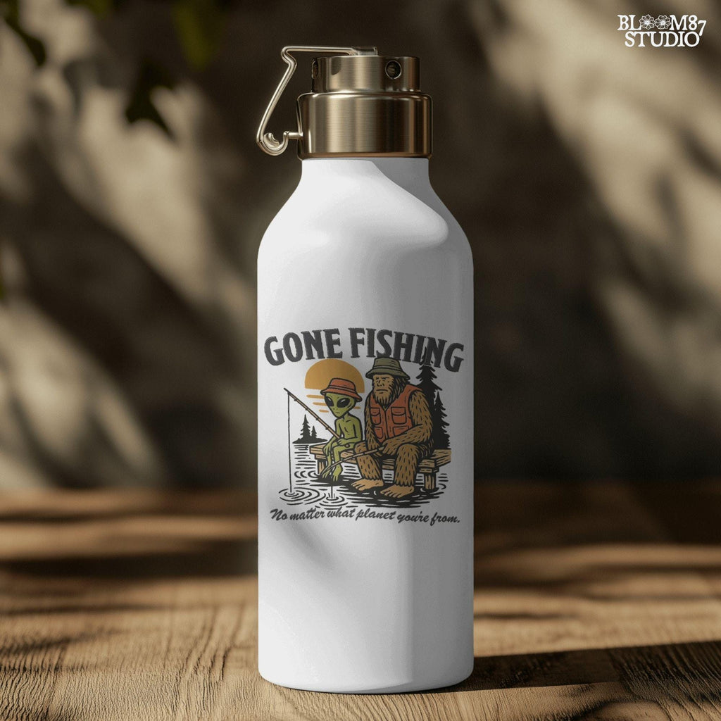 Funny illustration of Bigfoot and an alien fishing together on a lake dock at sunset, wearing fishing hats and vests—perfect for summer and Father’s Day sublimation.