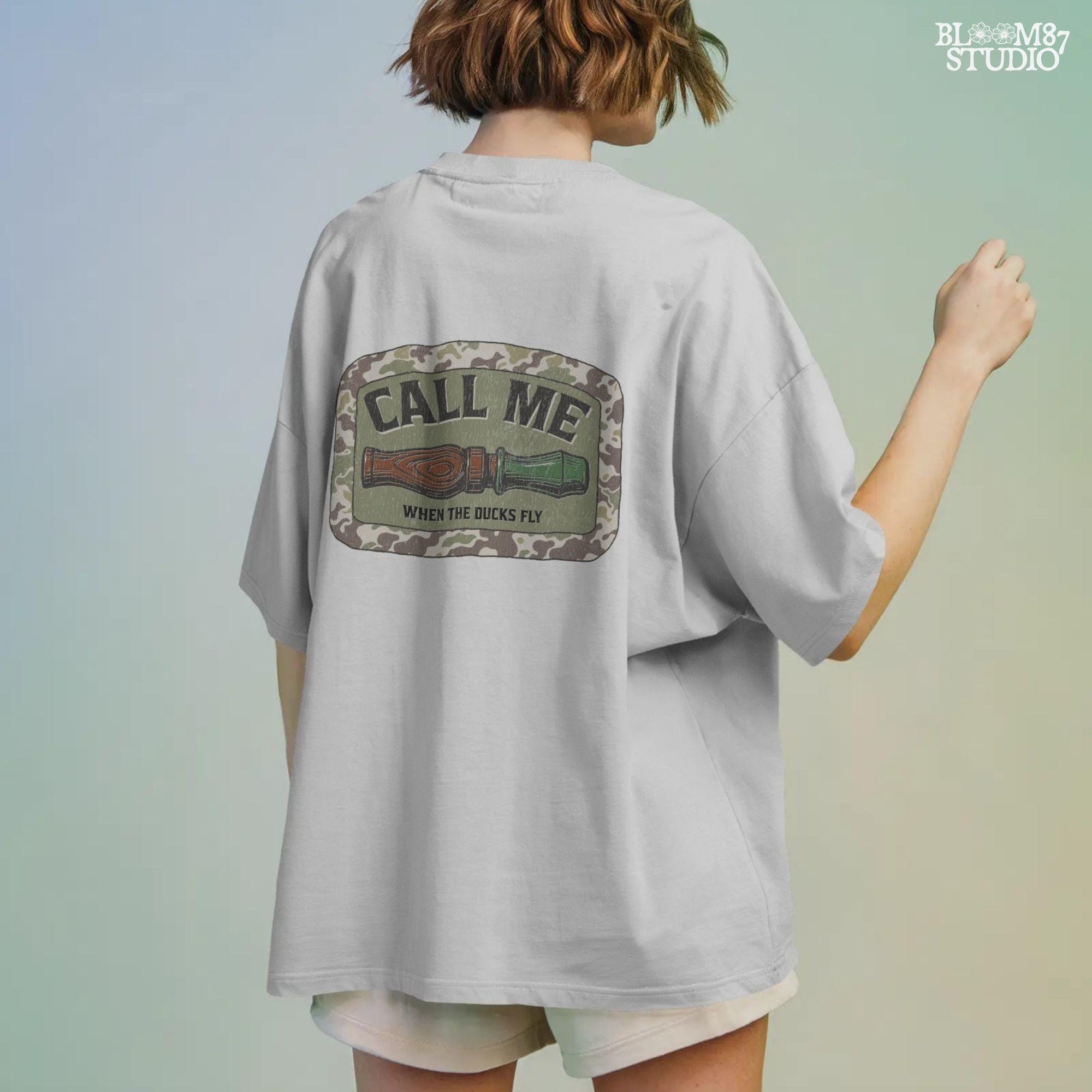 Sublimation PNG design featuring a duck call with camo border and the phrase “Call Me When The Ducks Fly” for hunting or outdoors shirts
