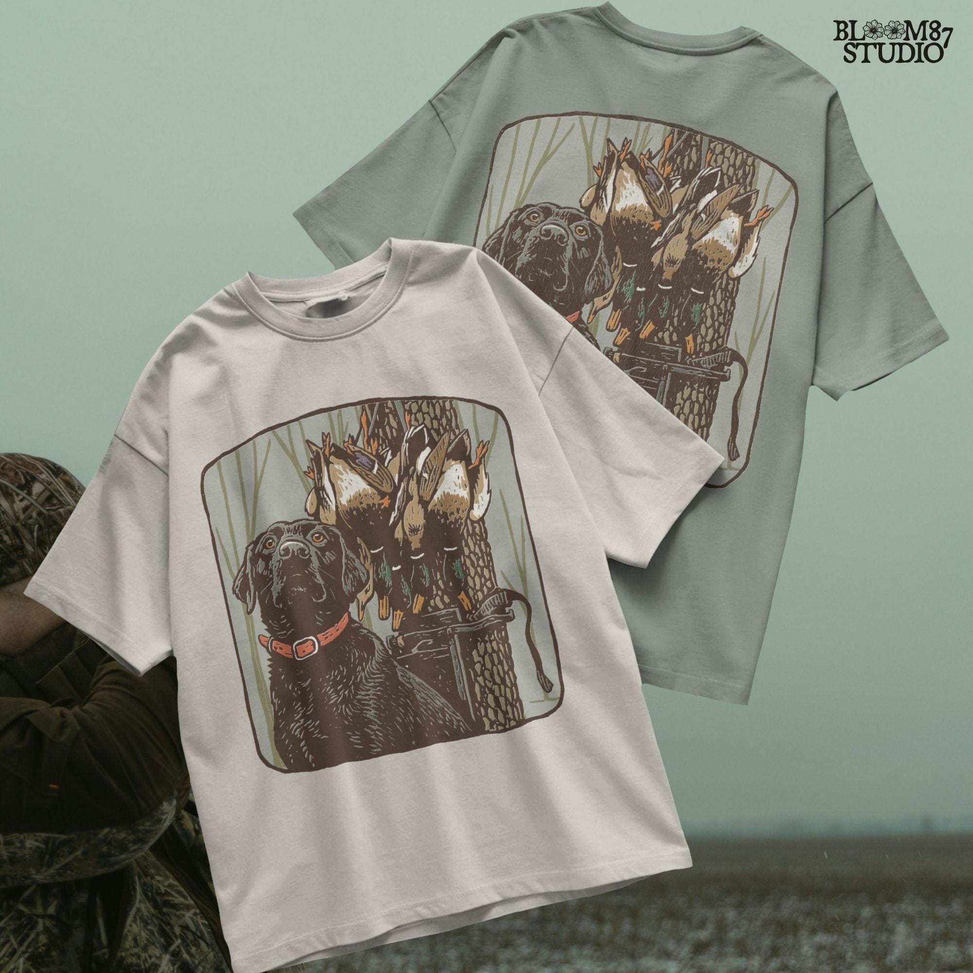 Digital PNG design of a black lab hunting dog with mallard ducks on a strap, ideal for sublimation printing on hunting-themed apparel