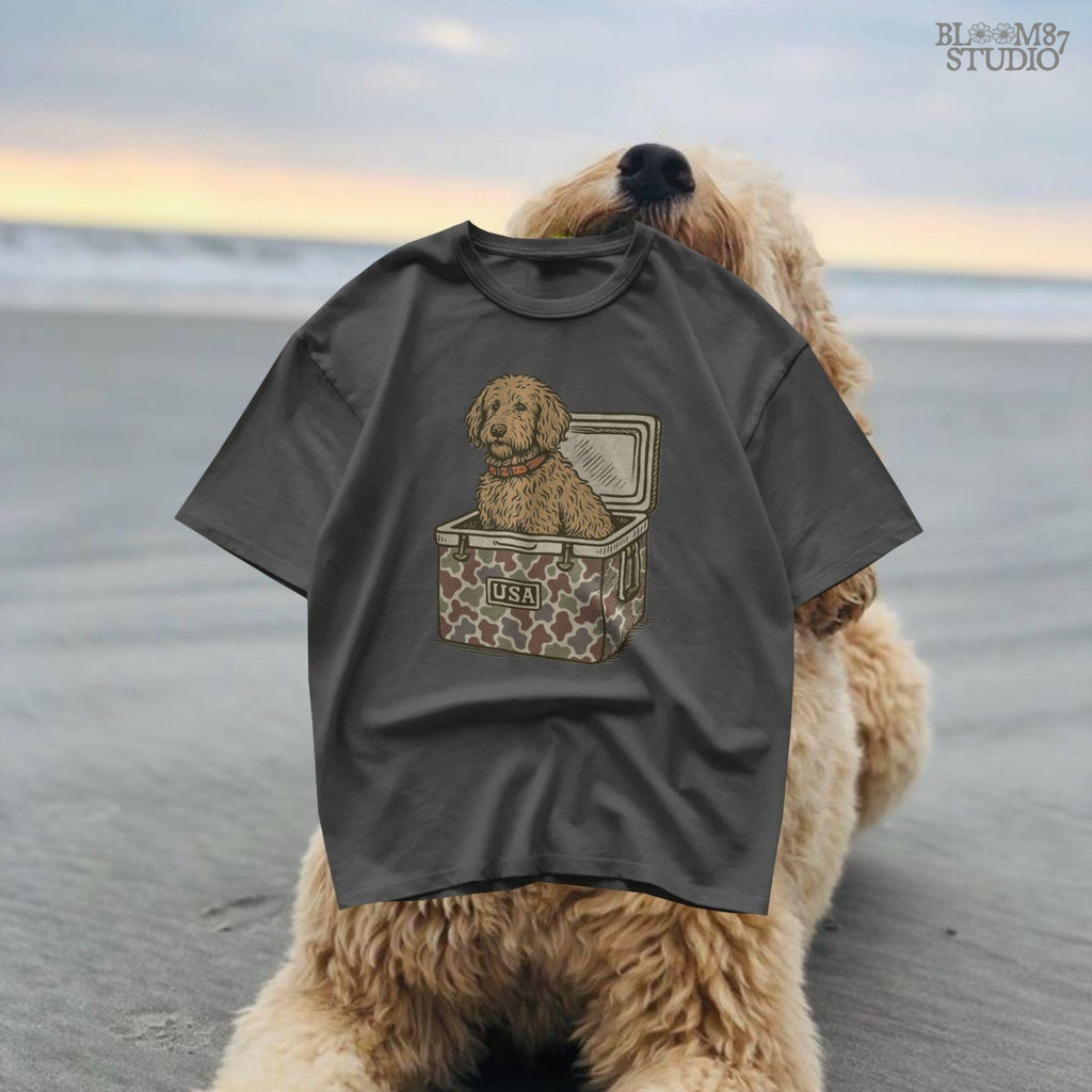Curly Goldendoodle dog sitting inside a USA camouflage cooler, digital PNG sublimation file for crafting patriotic pet-themed items.