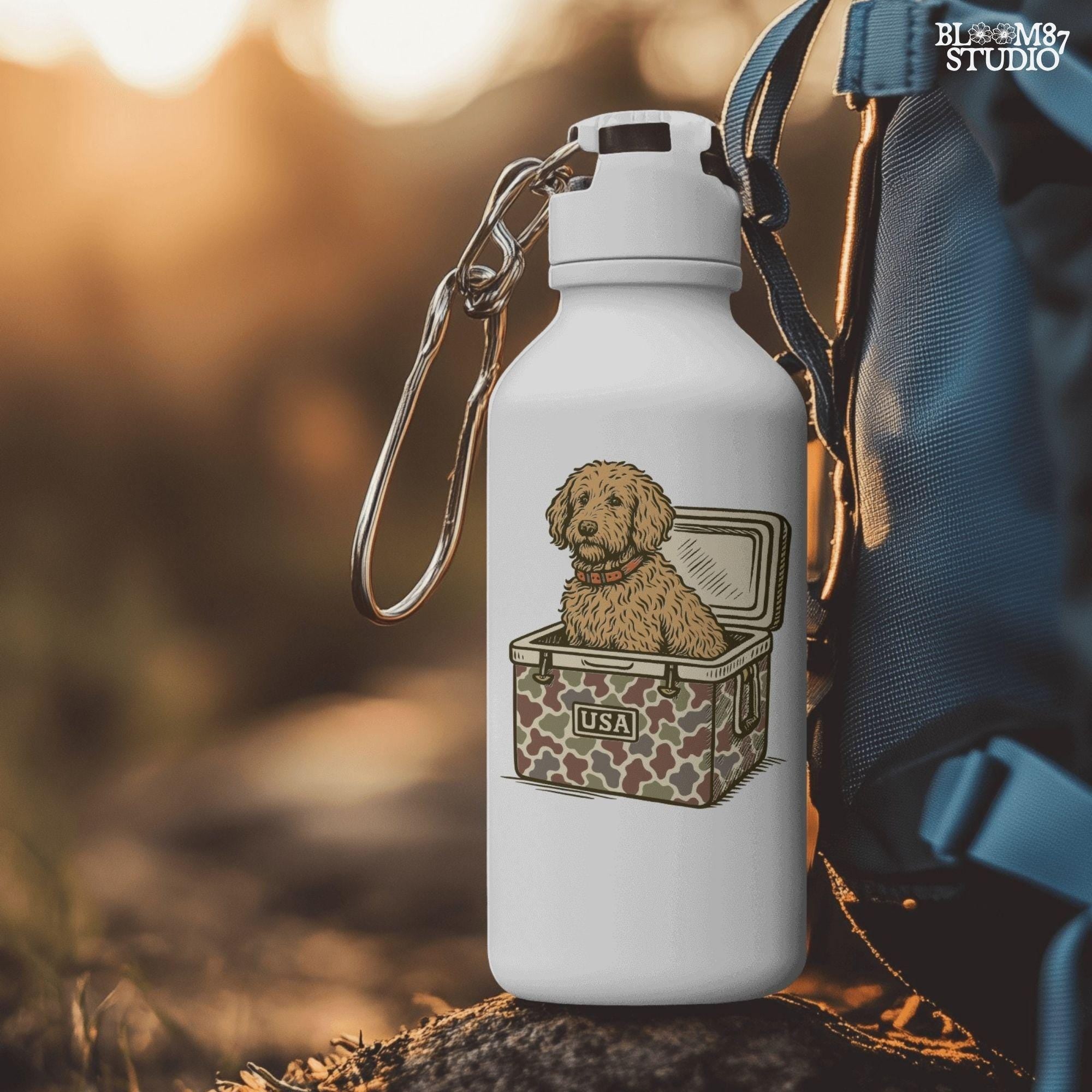 Curly Goldendoodle dog sitting inside a USA camouflage cooler, digital PNG sublimation file for crafting patriotic pet-themed items.