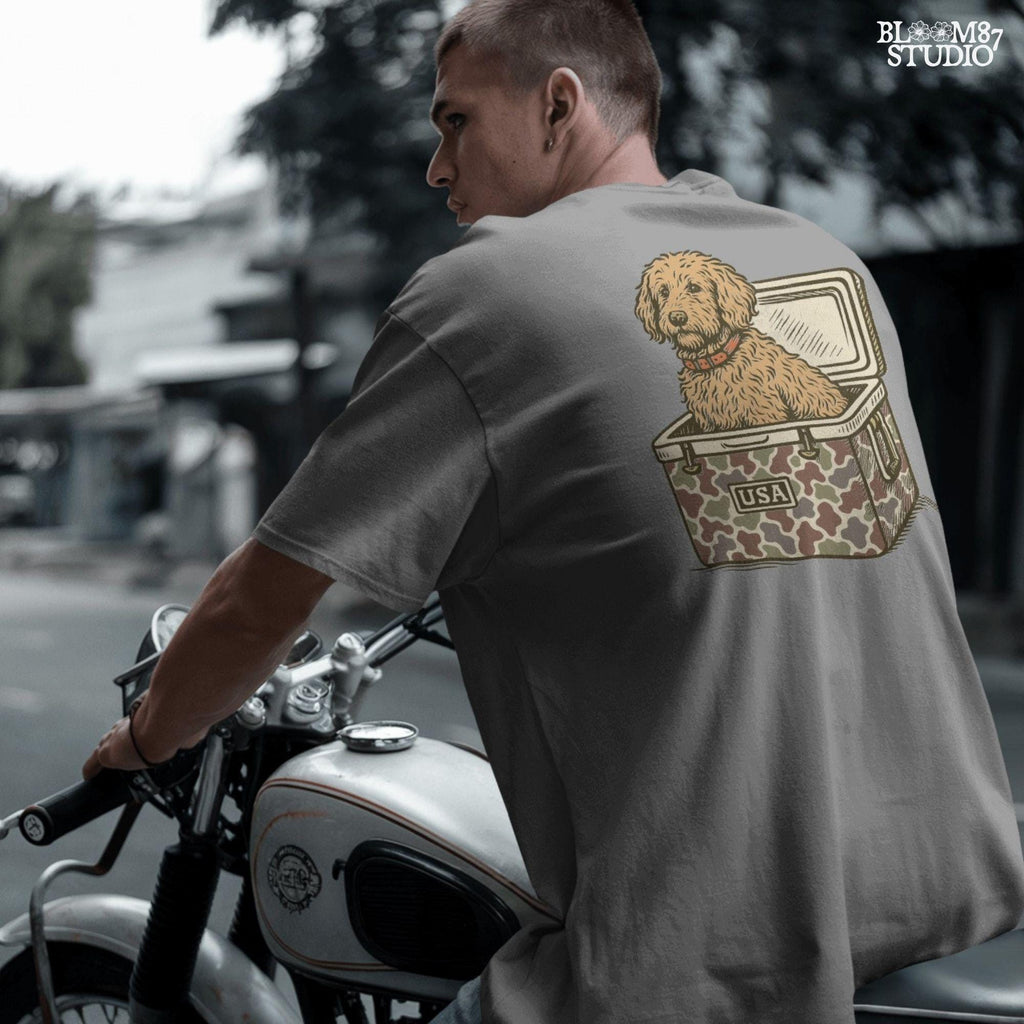 Curly Goldendoodle dog sitting inside a USA camouflage cooler, digital PNG sublimation file for crafting patriotic pet-themed items.