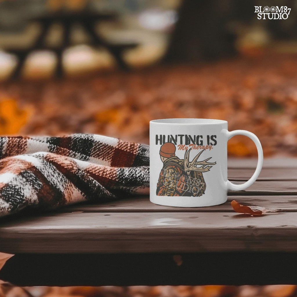 A camouflage hunter with antlers on backpack and text “Hunting Is My Therapy,” designed for fall hunting season sublimation and outdoor-themed apparel.