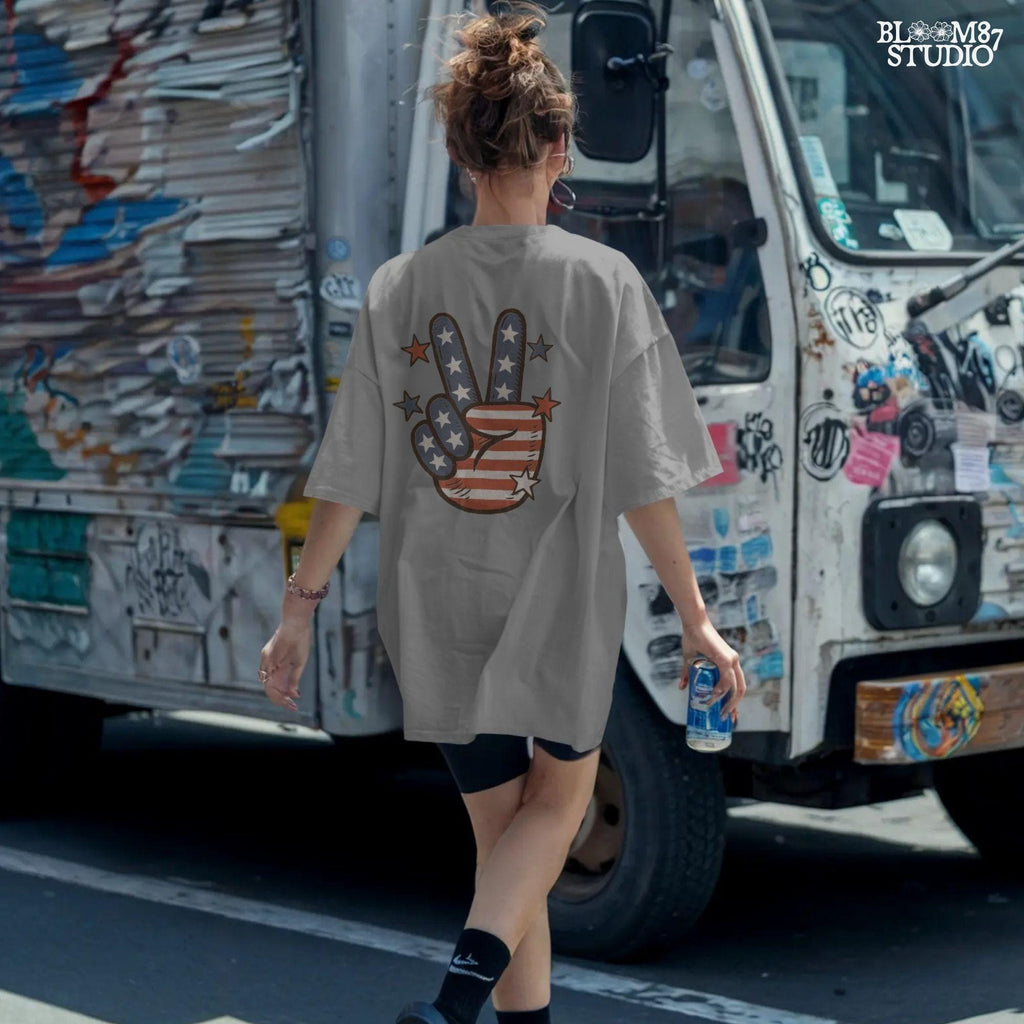 Peace hand symbol with stars and stripes in red, white, and blue American flag pattern surrounded by stars; retro patriotic sublimation art.