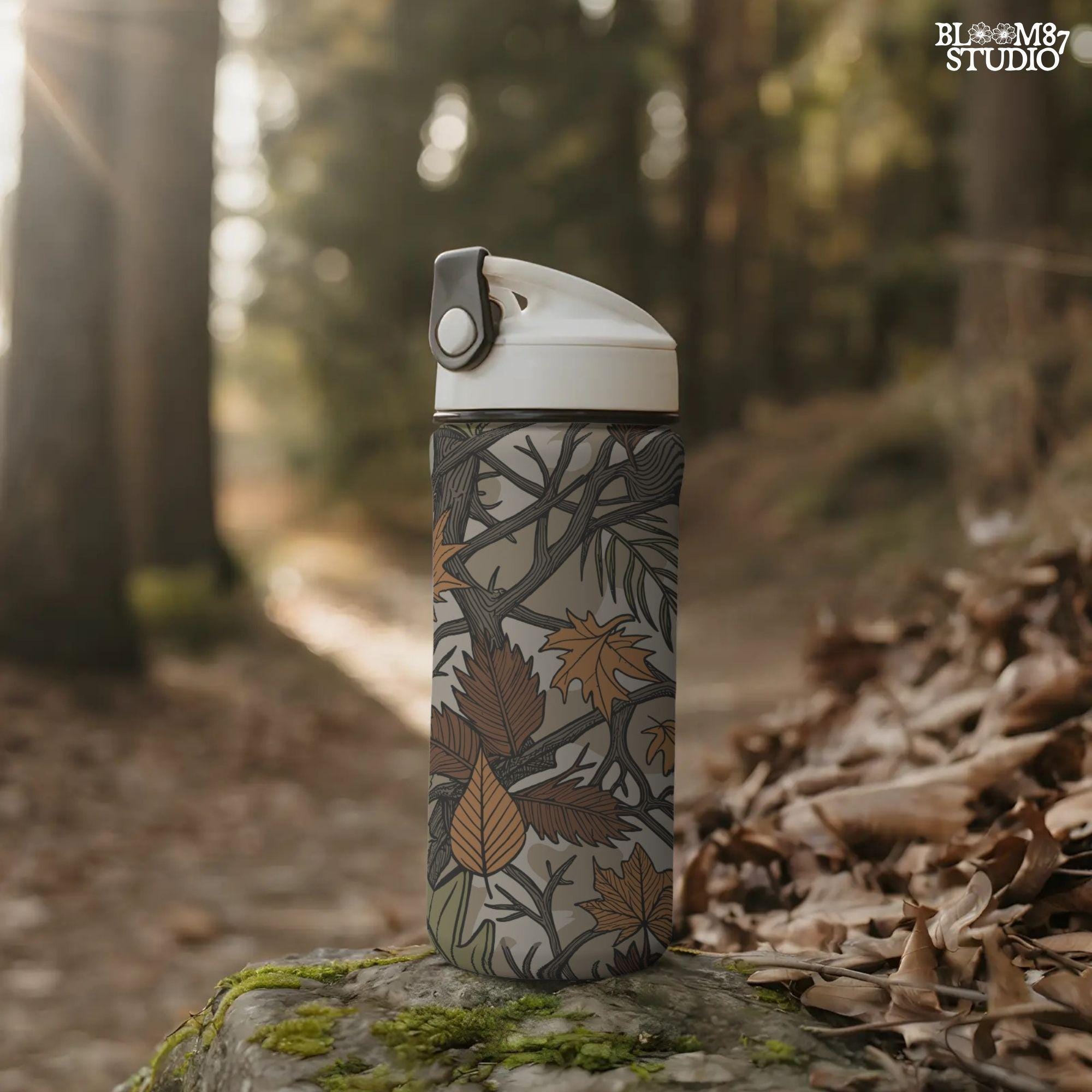 Seamless camouflage PNG pattern with autumn leaves, tree branches, and earthy tones of orange, brown, and green for fall sublimation use.