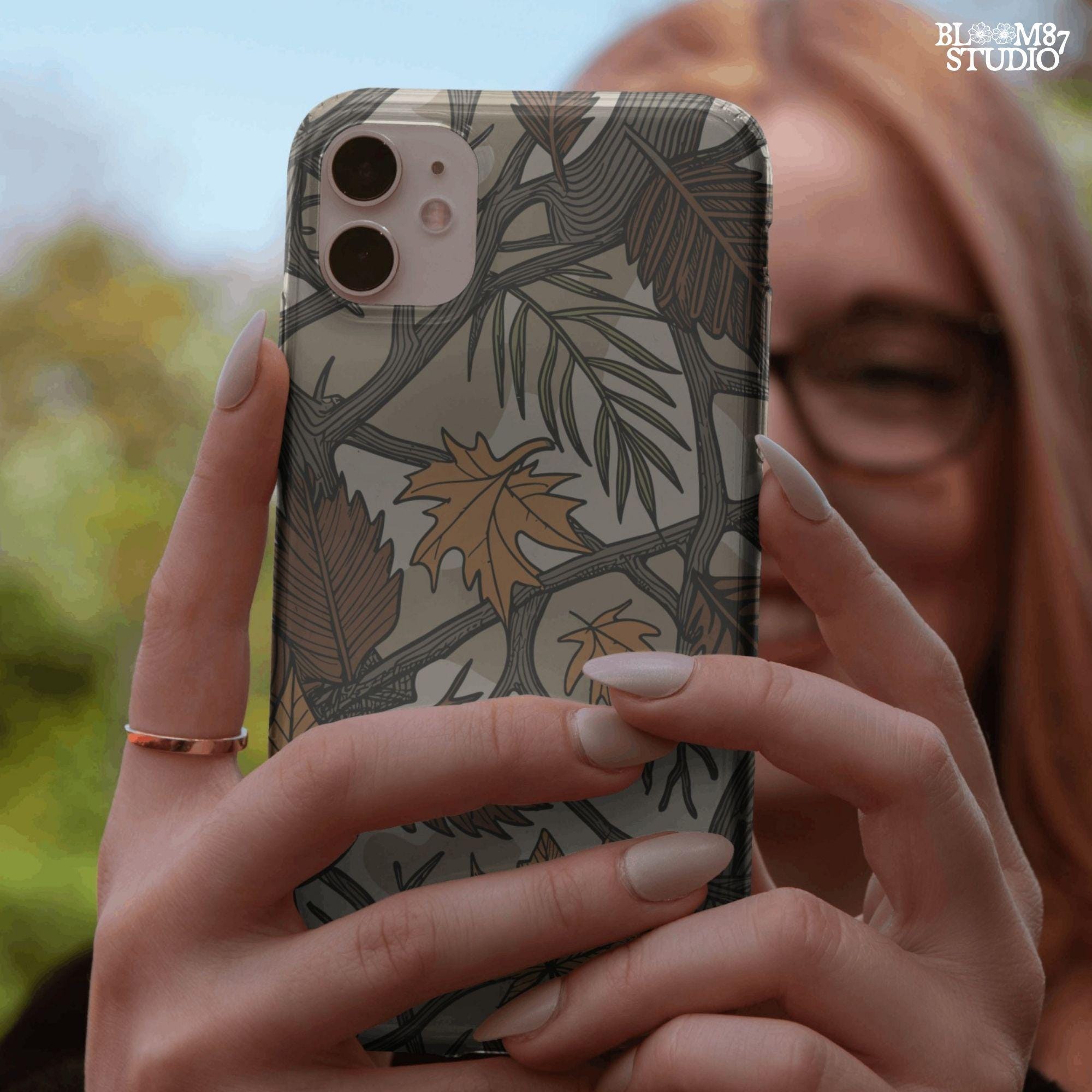 Seamless camouflage PNG pattern with autumn leaves, tree branches, and earthy tones of orange, brown, and green for fall sublimation use.