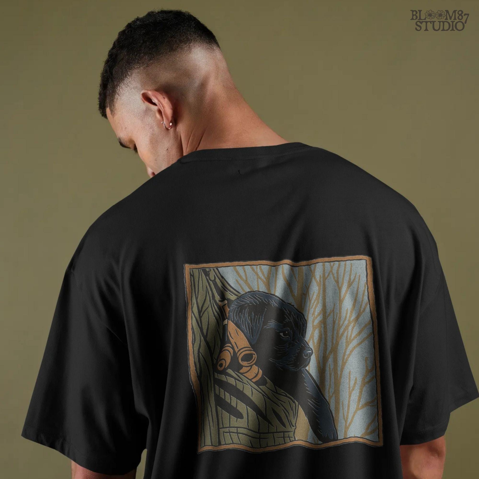 Black Labrador puppy sitting in a camo hunting vest with duck calls, perfect for fall hunting season sublimation designs.