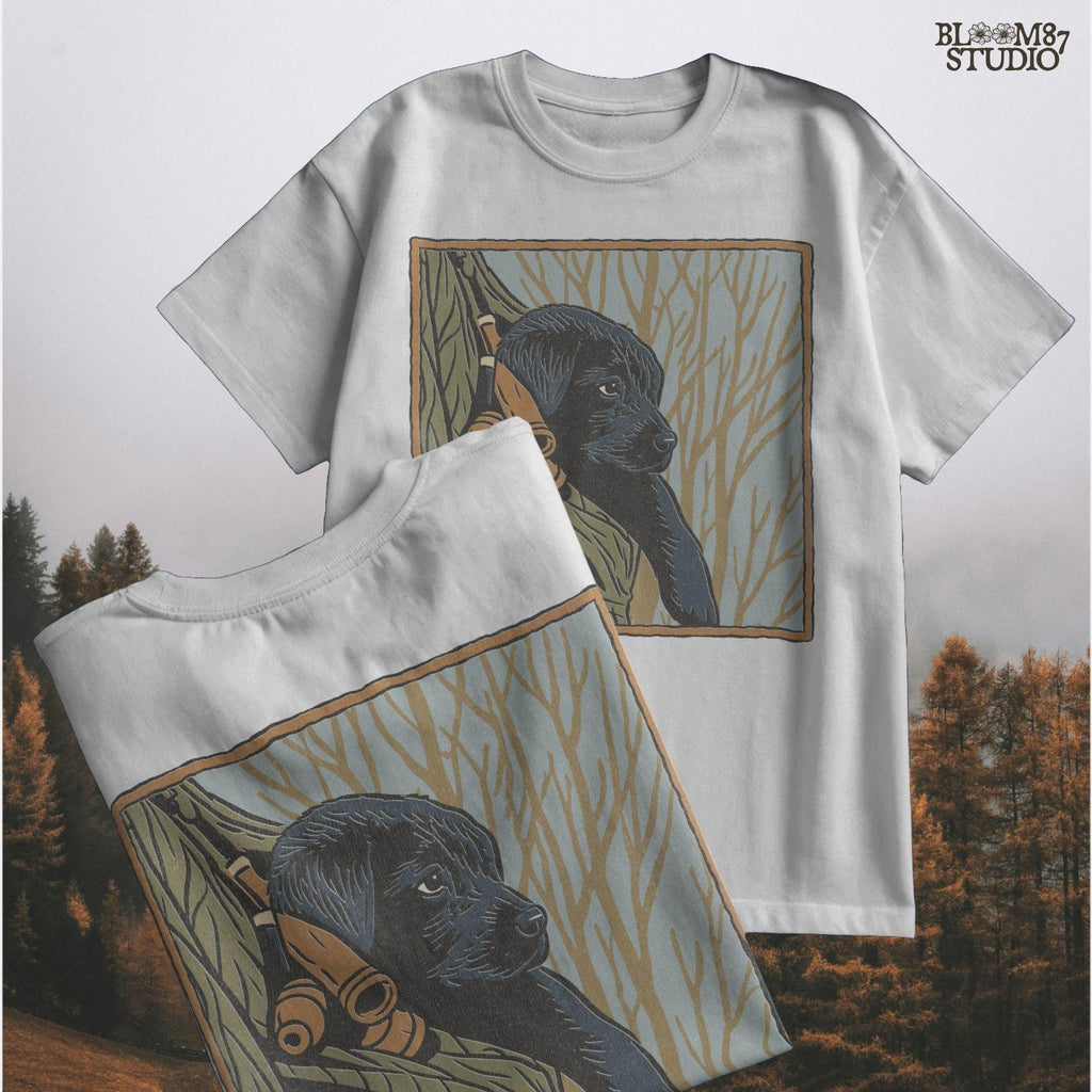 Black Labrador puppy sitting in a camo hunting vest with duck calls, perfect for fall hunting season sublimation designs.