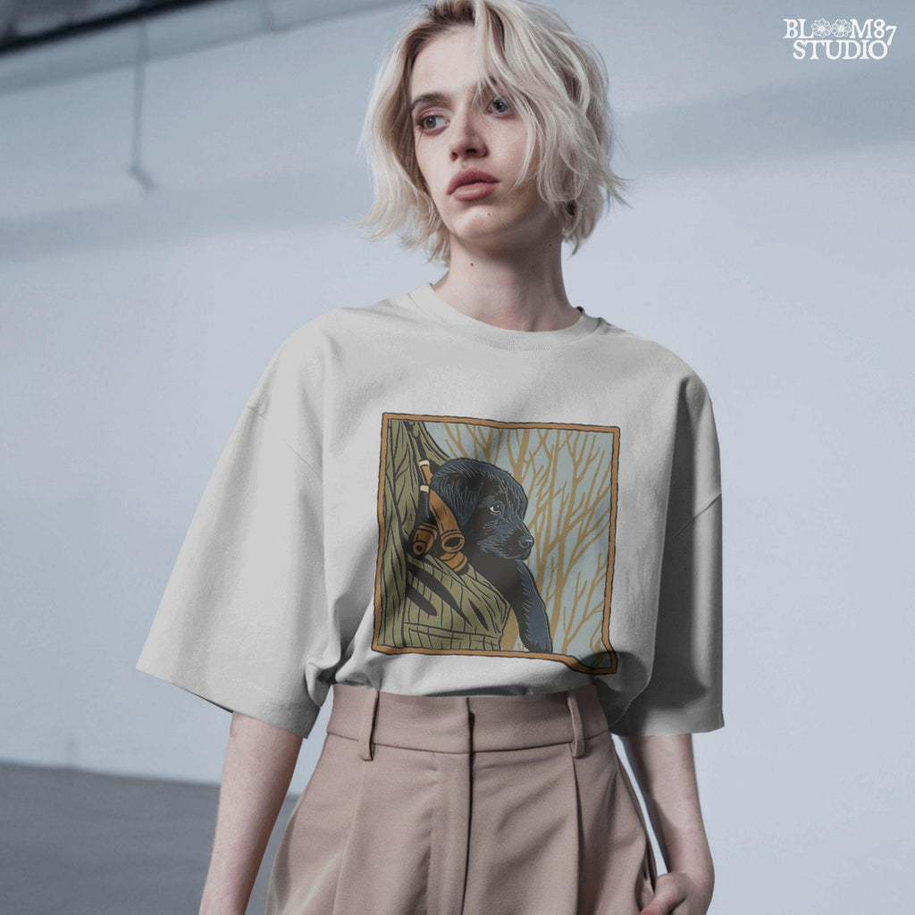 Black Labrador puppy sitting in a camo hunting vest with duck calls, perfect for fall hunting season sublimation designs.