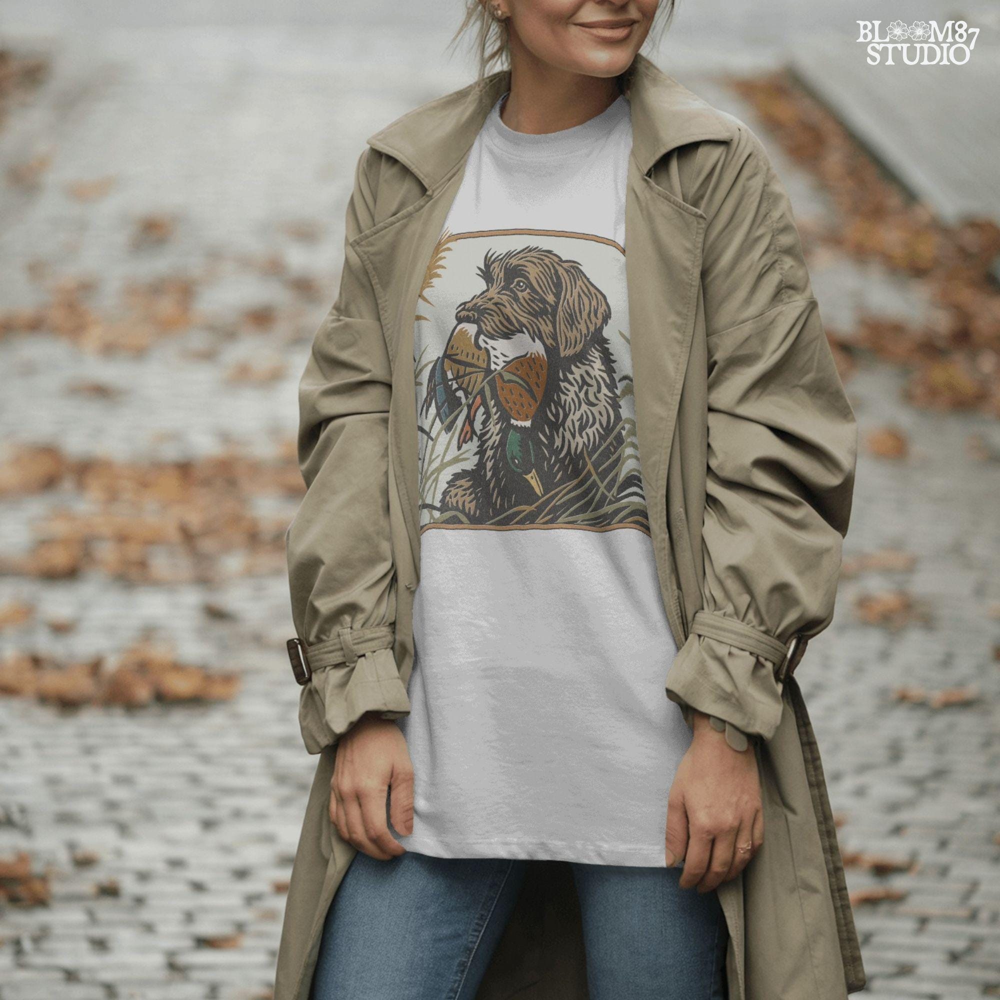 Wirehaired hunting dog holding a mallard duck in its mouth, surrounded by tall grass in a fall marsh scene, sublimation PNG for hunting-themed designs.