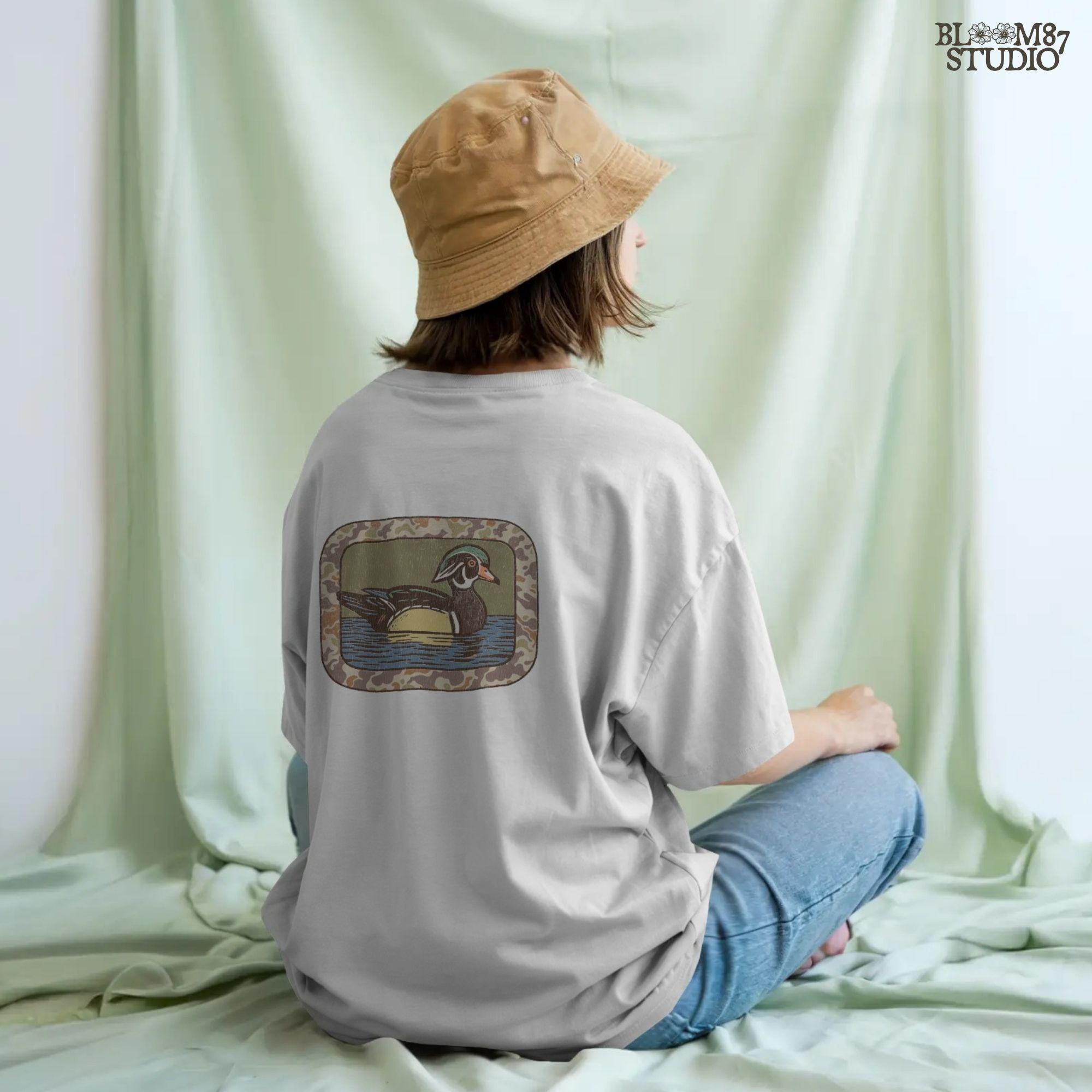 Rustic wood duck illustration with green, brown, and tan camo border; sublimation PNG for hunting or wildlife-themed crafts and apparel.