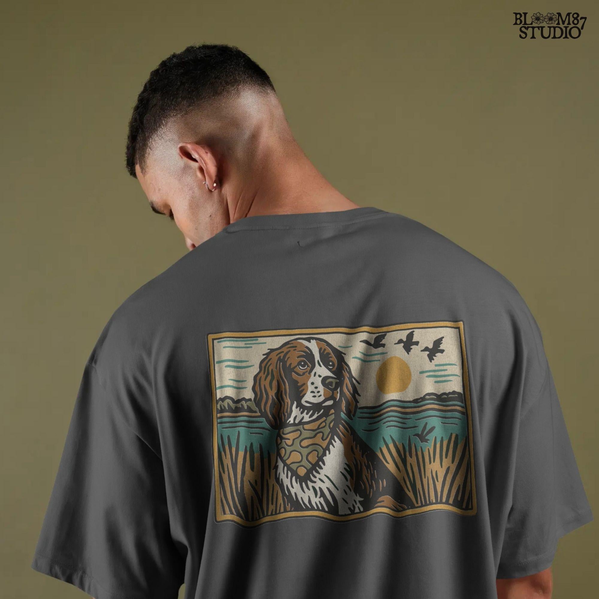 Illustration of a spaniel dog in a camouflage bandana sitting near a lake with sunset and ducks flying overhead; rustic southern sublimation PNG for apparel.