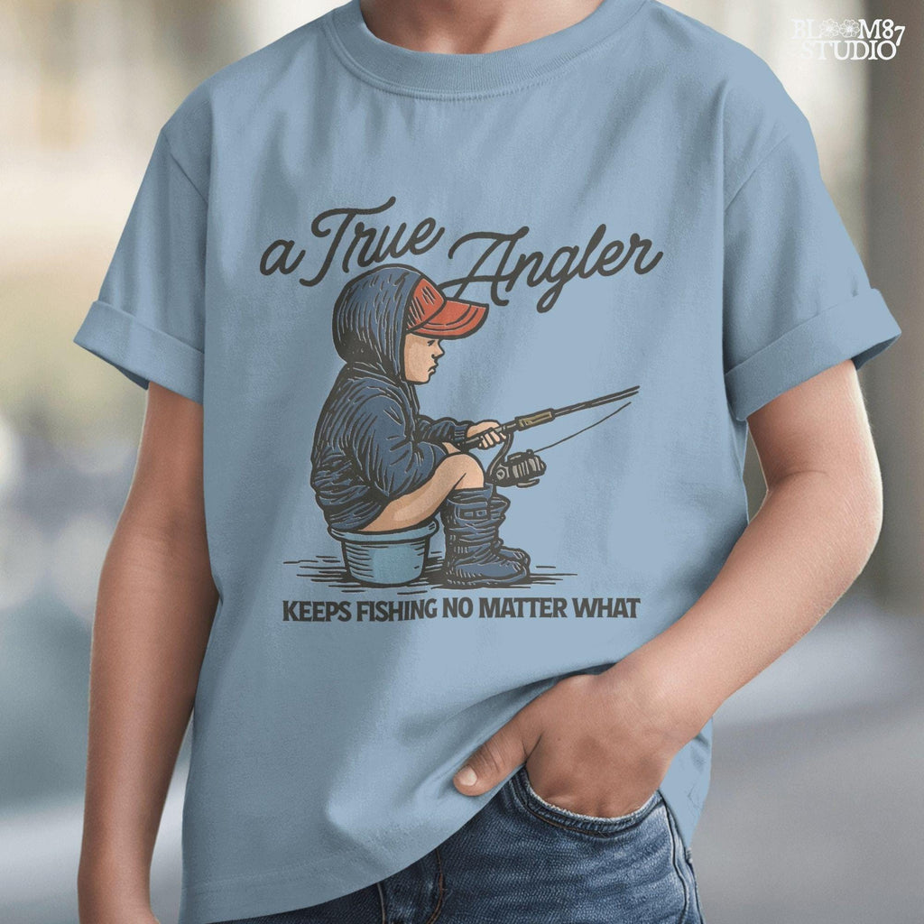 Cartoon of young boy sitting on a bucket in hoodie and boots, fishing with full focus, with the quote “A True Angler Keeps Fishing No Matter What.”
