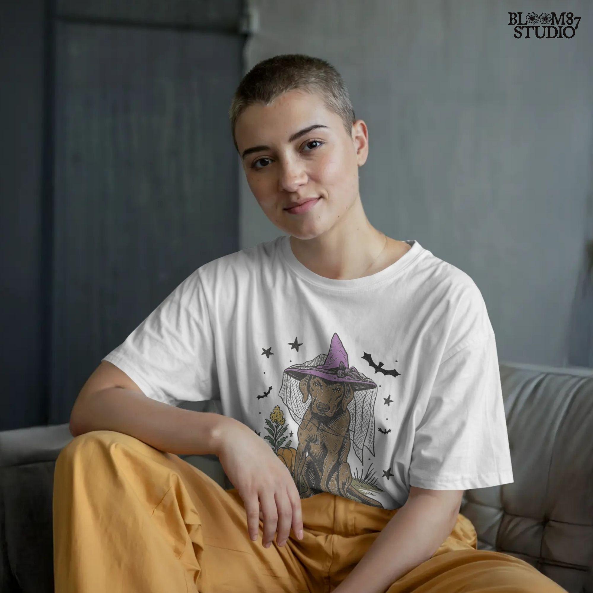 Illustration of a brown labrador wearing a witch hat, sitting in grass with pumpkins and stars in the background, in Halloween spooky style.