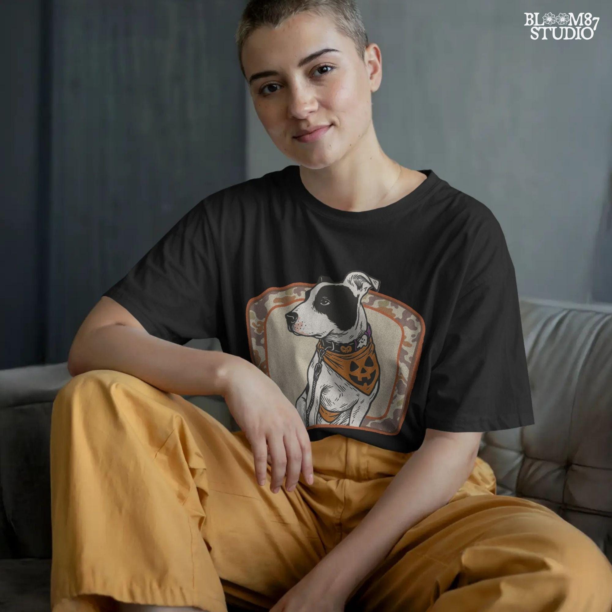 Illustration of a black and white pitbull wearing a jack-o’-lantern bandana and Halloween collar, framed by a camo background.