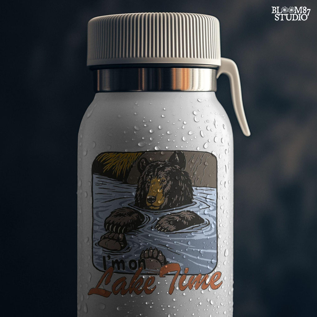 Cartoon bear relaxing in a lake with paws up, text reads “I’m on Lake Time,” in a cozy, vintage outdoor style.