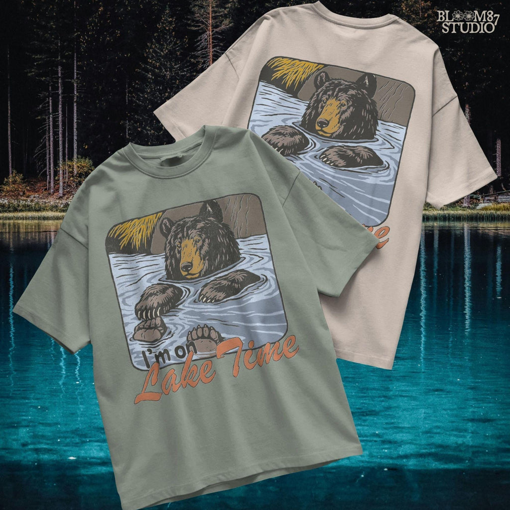 Cartoon bear relaxing in a lake with paws up, text reads “I’m on Lake Time,” in a cozy, vintage outdoor style.