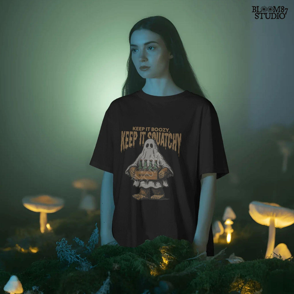 Funny Bigfoot dressed as a ghost holding a six-pack labeled “Boo Brew,” with spooky text “Keep It Boozy, Keep It Squatchy” above.