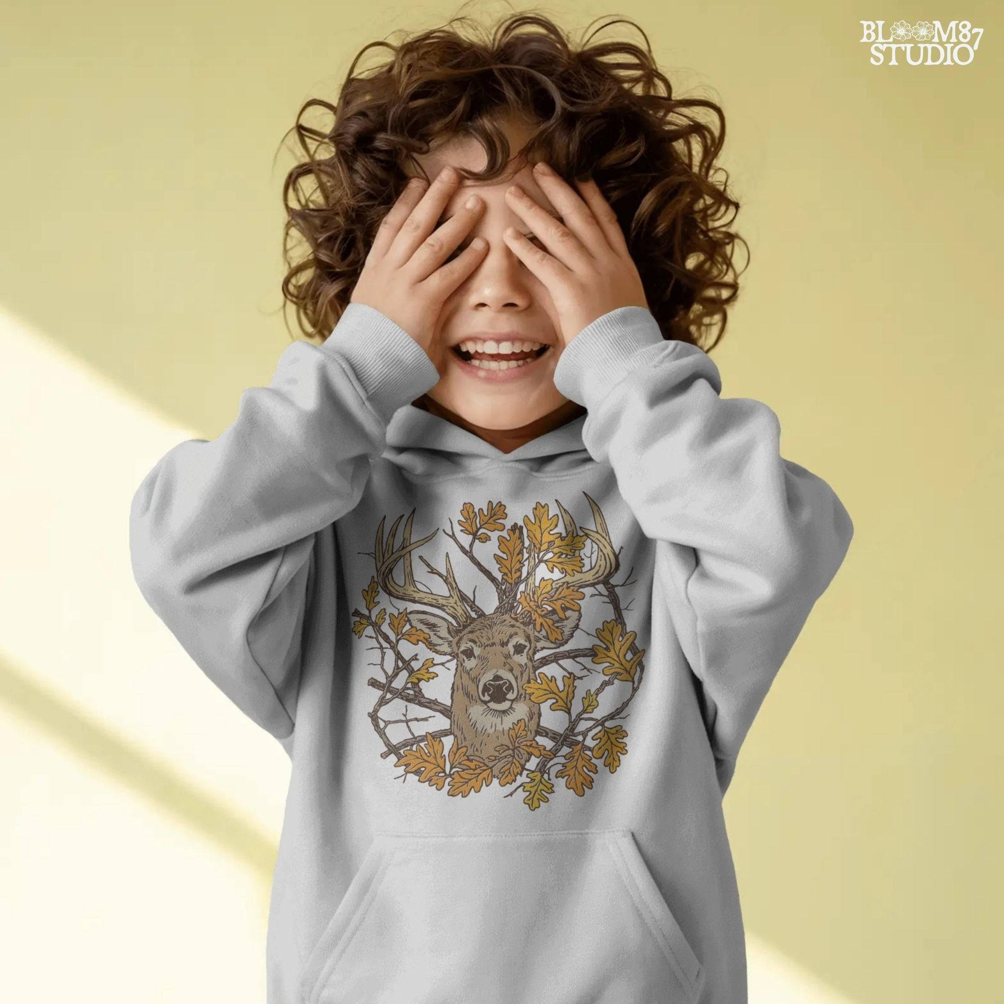 Illustration of a whitetail deer head with large antlers surrounded by golden autumn oak leaves and forest branches, rustic fall theme.