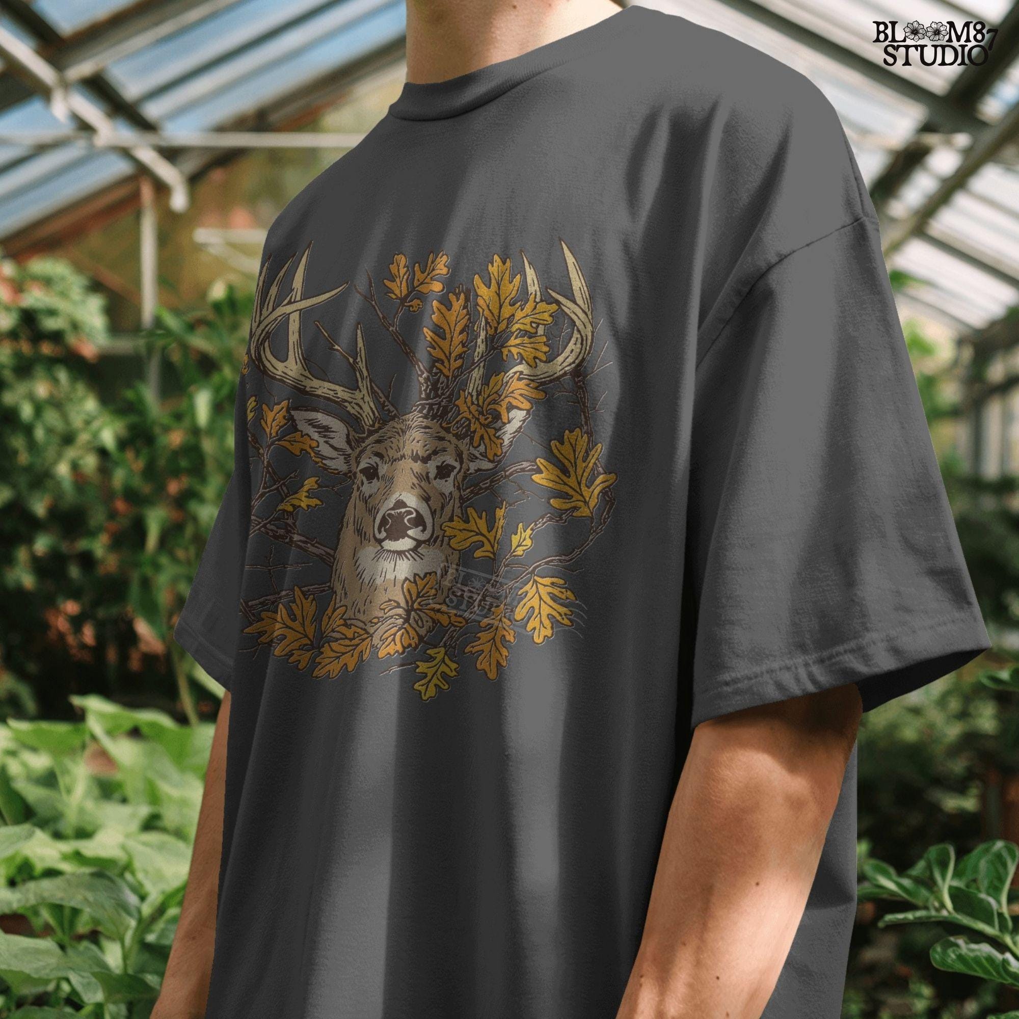 Illustration of a whitetail deer head with large antlers surrounded by golden autumn oak leaves and forest branches, rustic fall theme.