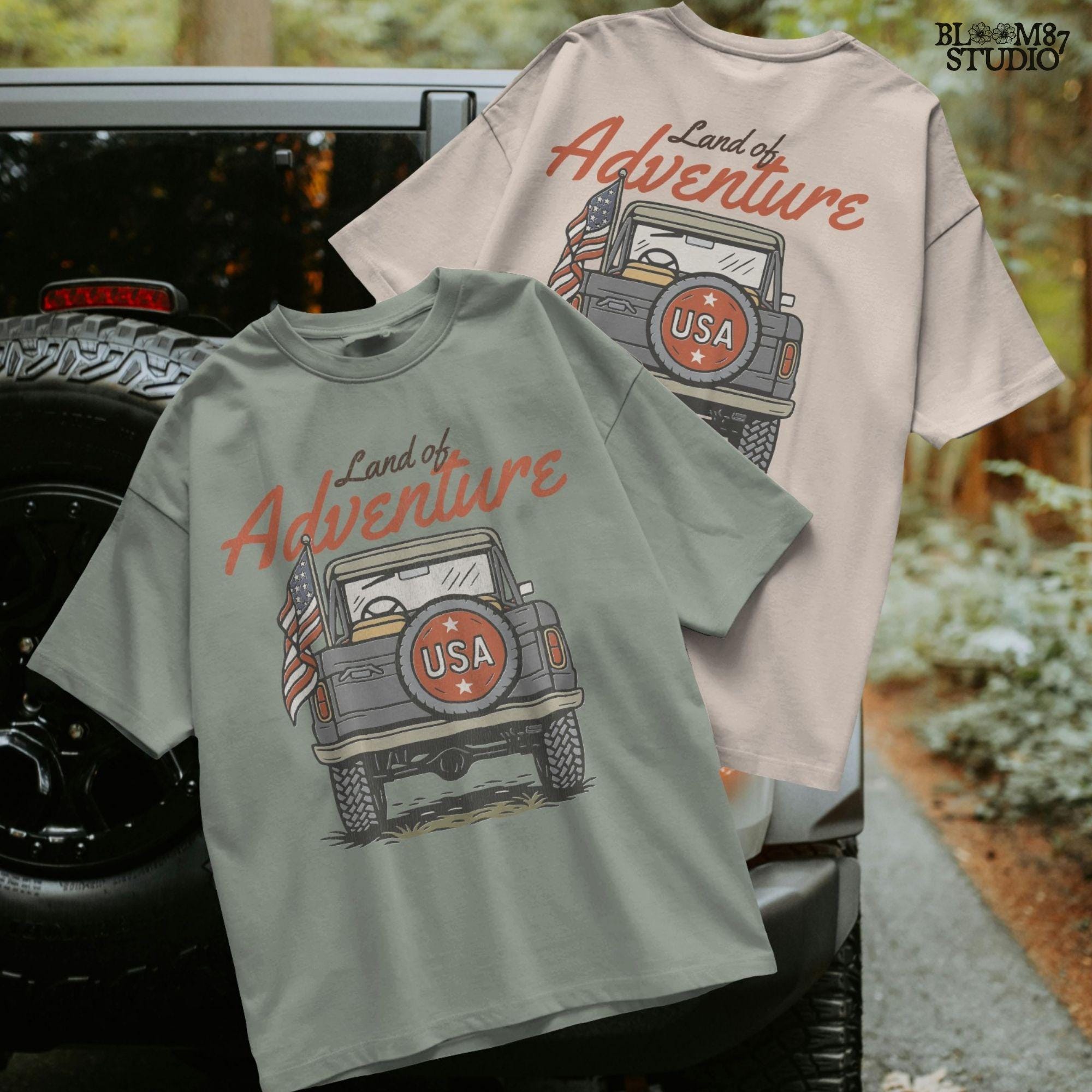 Vintage offroad truck seen from the back with “USA” spare tire and waving American flag, text reads “Land of Adventure” in retro patriotic style.