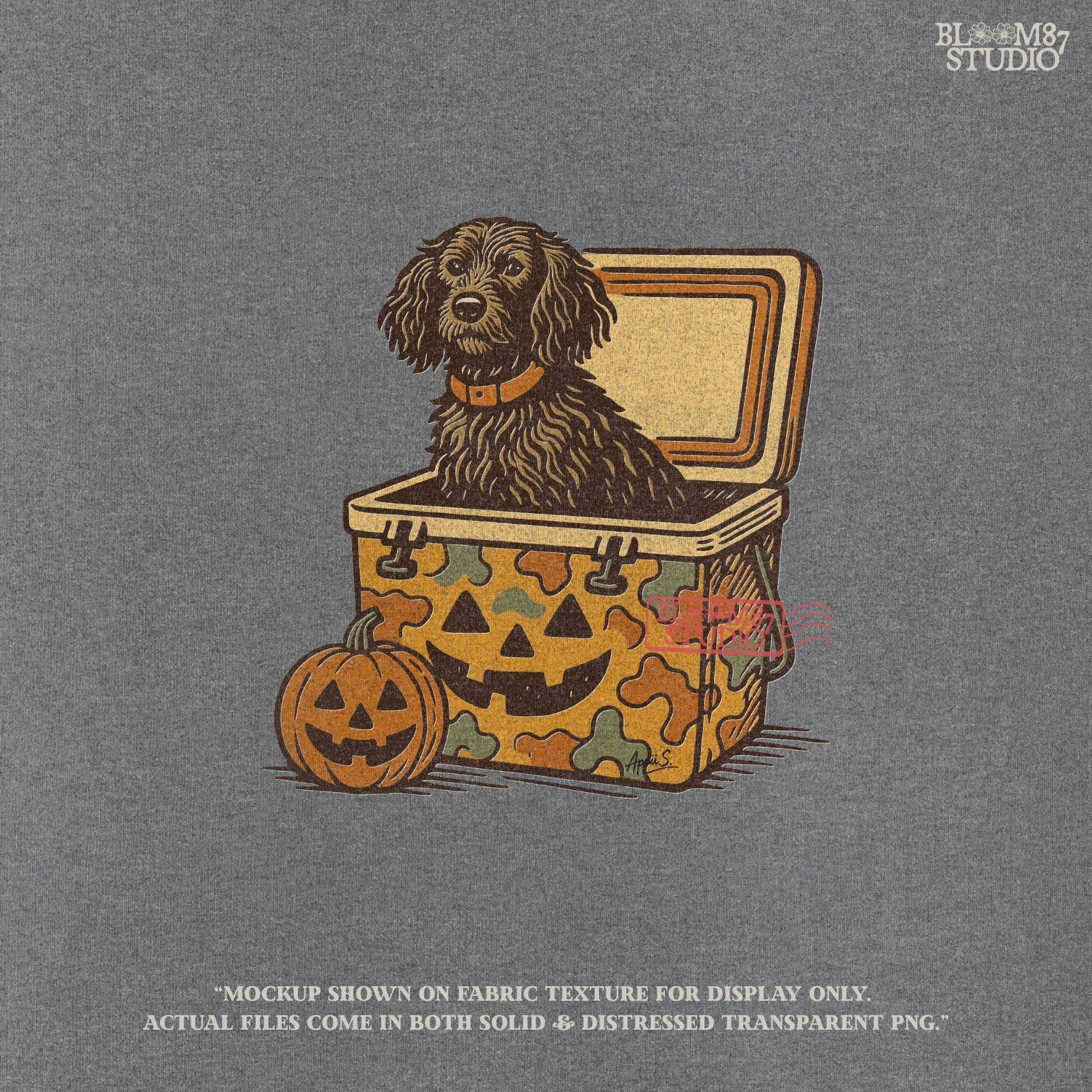 Halloween-themed PNG of a fluffy dog sitting inside a pumpkin-faced camouflage cooler, with jack-o’-lantern pumpkins next to it.