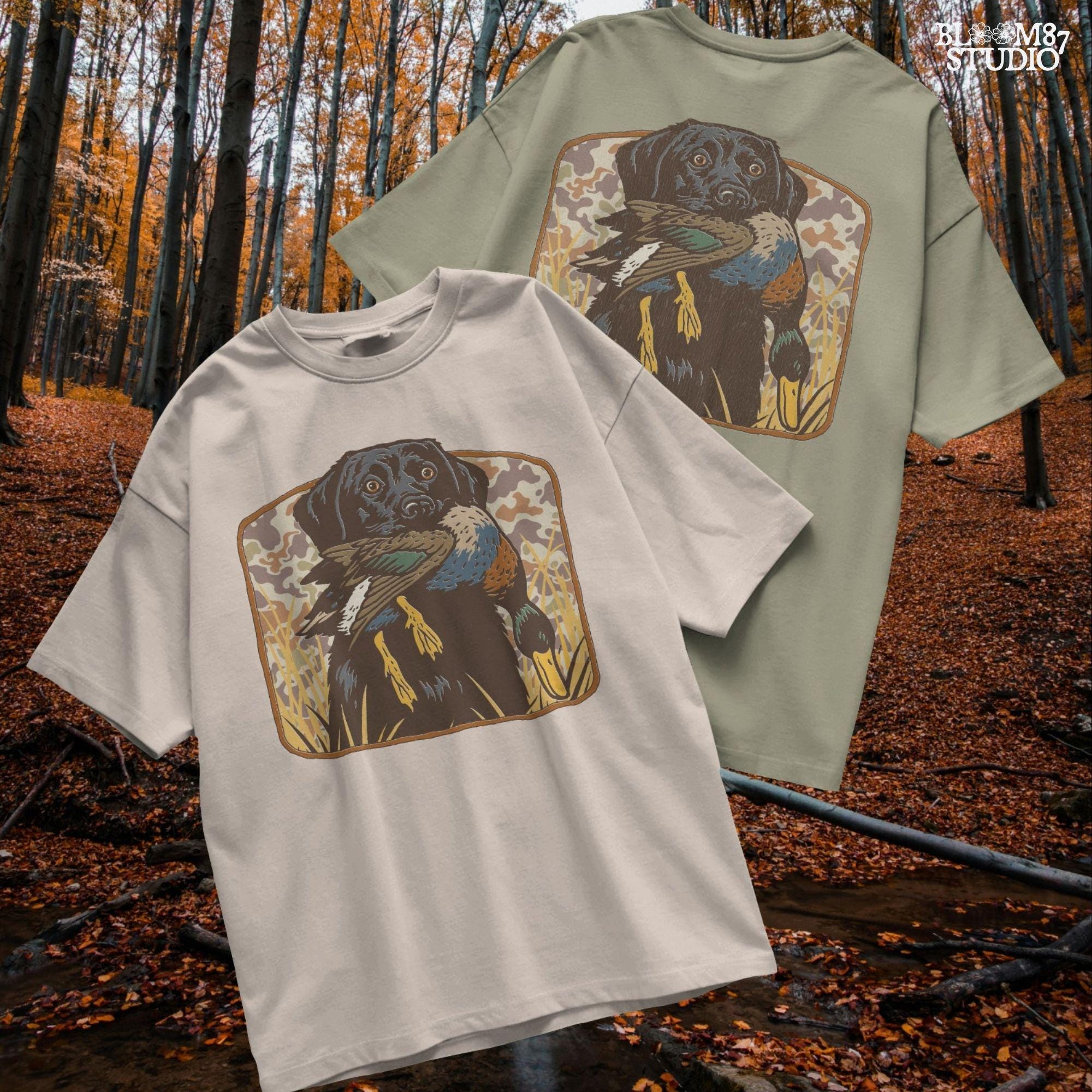 Vintage-style illustration of a black Labrador retriever holding a mallard duck in its mouth with a camouflage background, ideal for duck hunting designs.