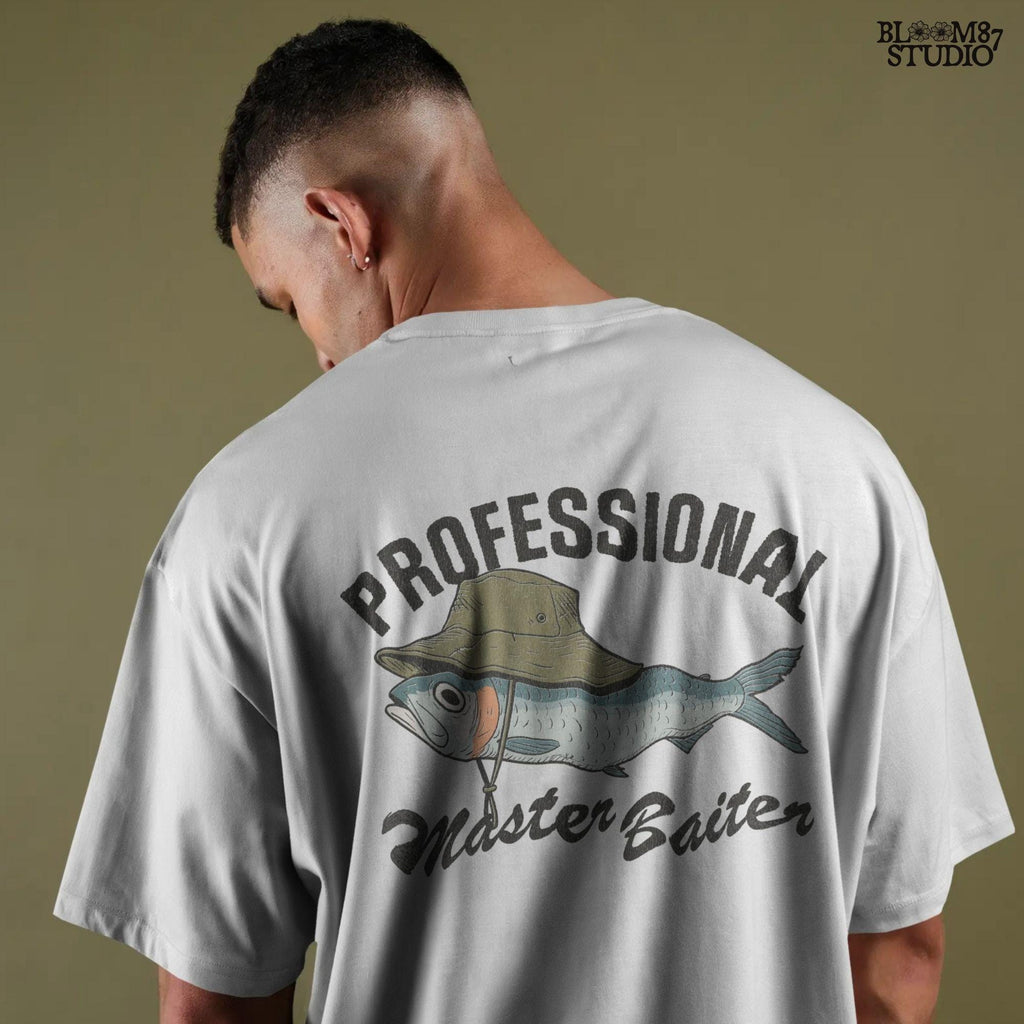 Funny fishing sublimation PNG with a fish wearing a green bucket hat and the words “Professional Master Baiter” in vintage bold font.