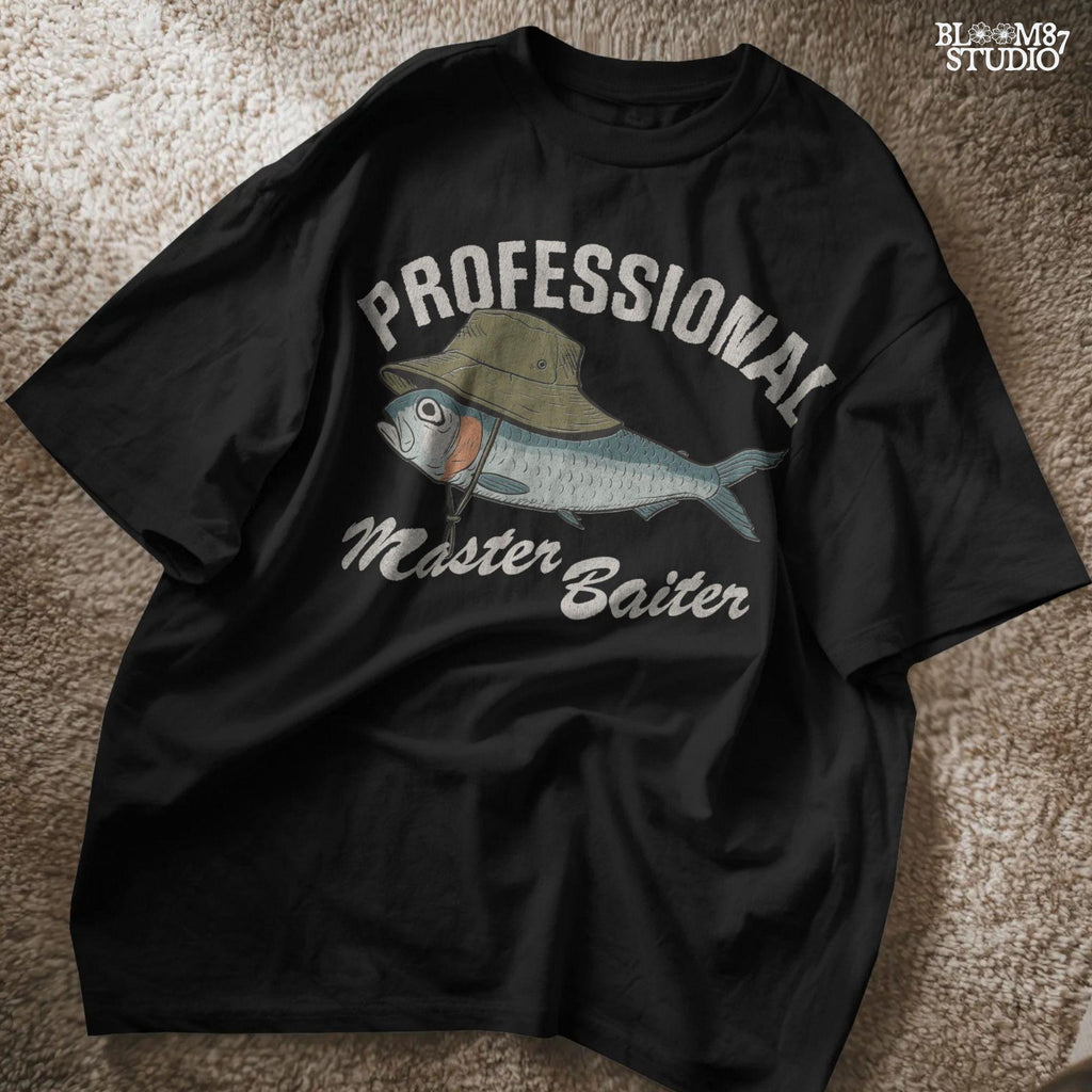 Funny fishing sublimation PNG with a fish wearing a green bucket hat and the words “Professional Master Baiter” in vintage bold font.