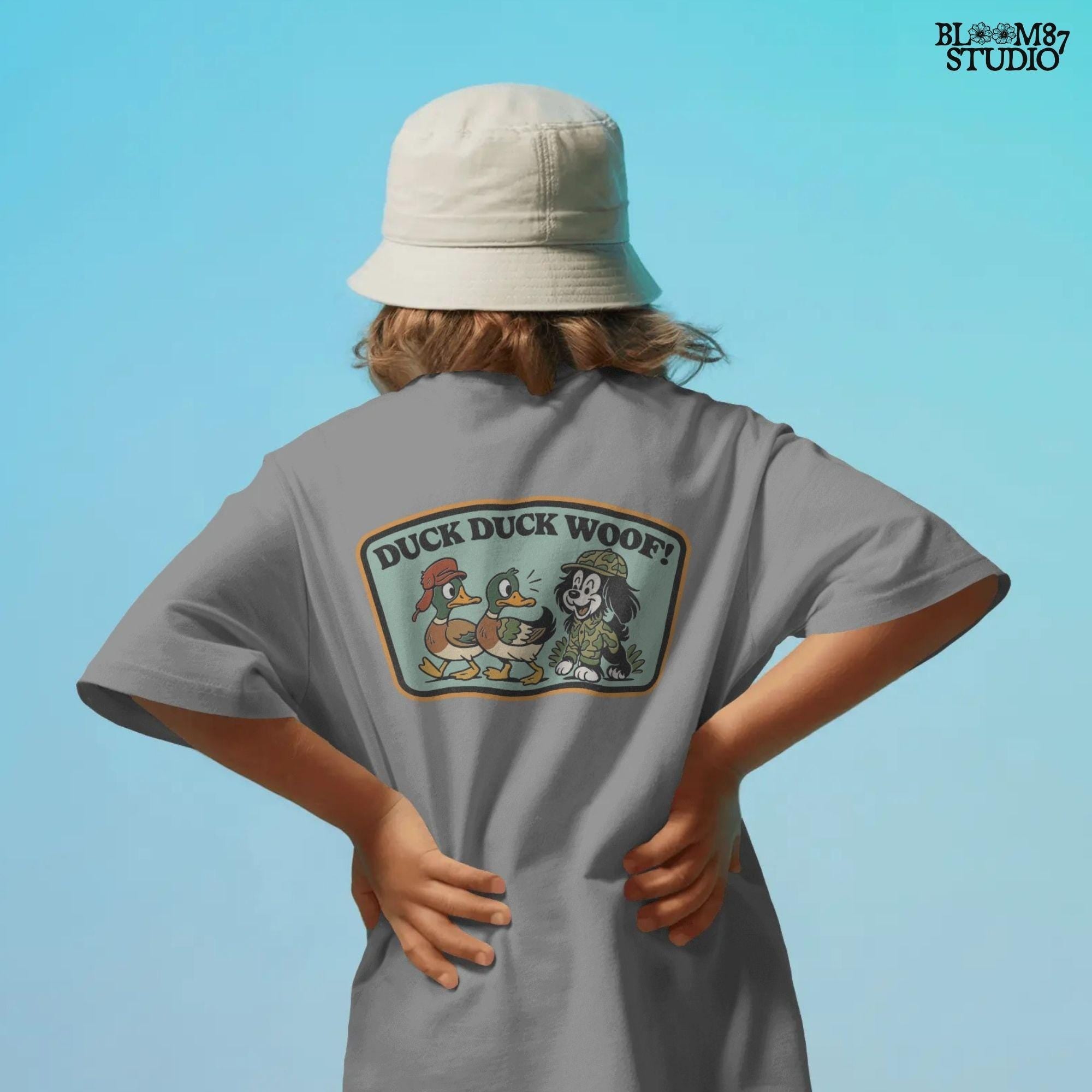 Cartoon hunting dog in camo outfit (front design) and back scene with ducks and the same dog with “Duck Duck Woof!” text – cute front and back PNG set for kids.