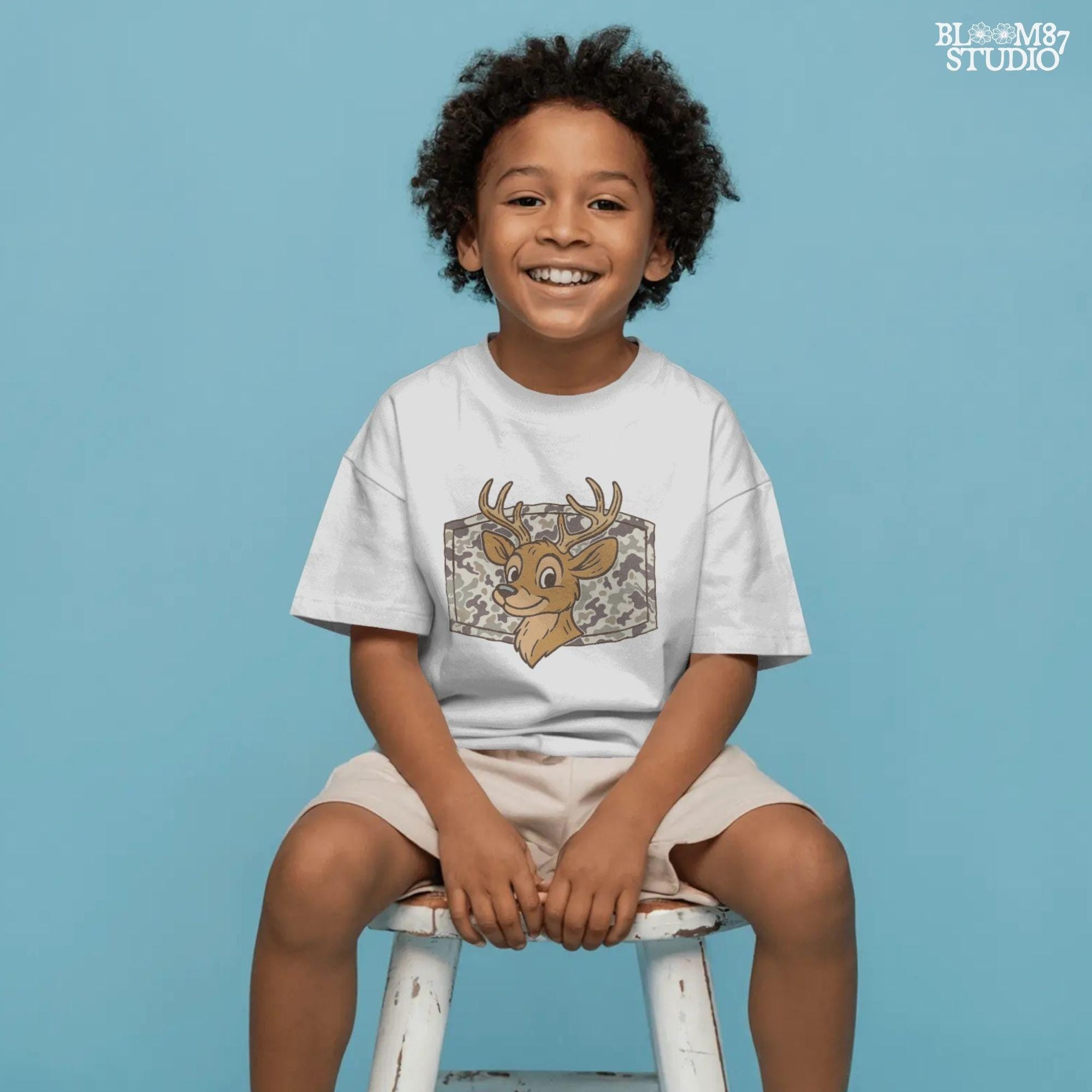 Cartoon deer with big antlers in front of a camouflage background – sublimation PNG design for fall, back to school, or kids’ hunting season shirts.