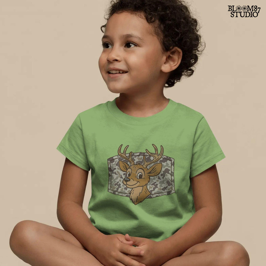 Cartoon deer with big antlers in front of a camouflage background – sublimation PNG design for fall, back to school, or kids’ hunting season shirts.
