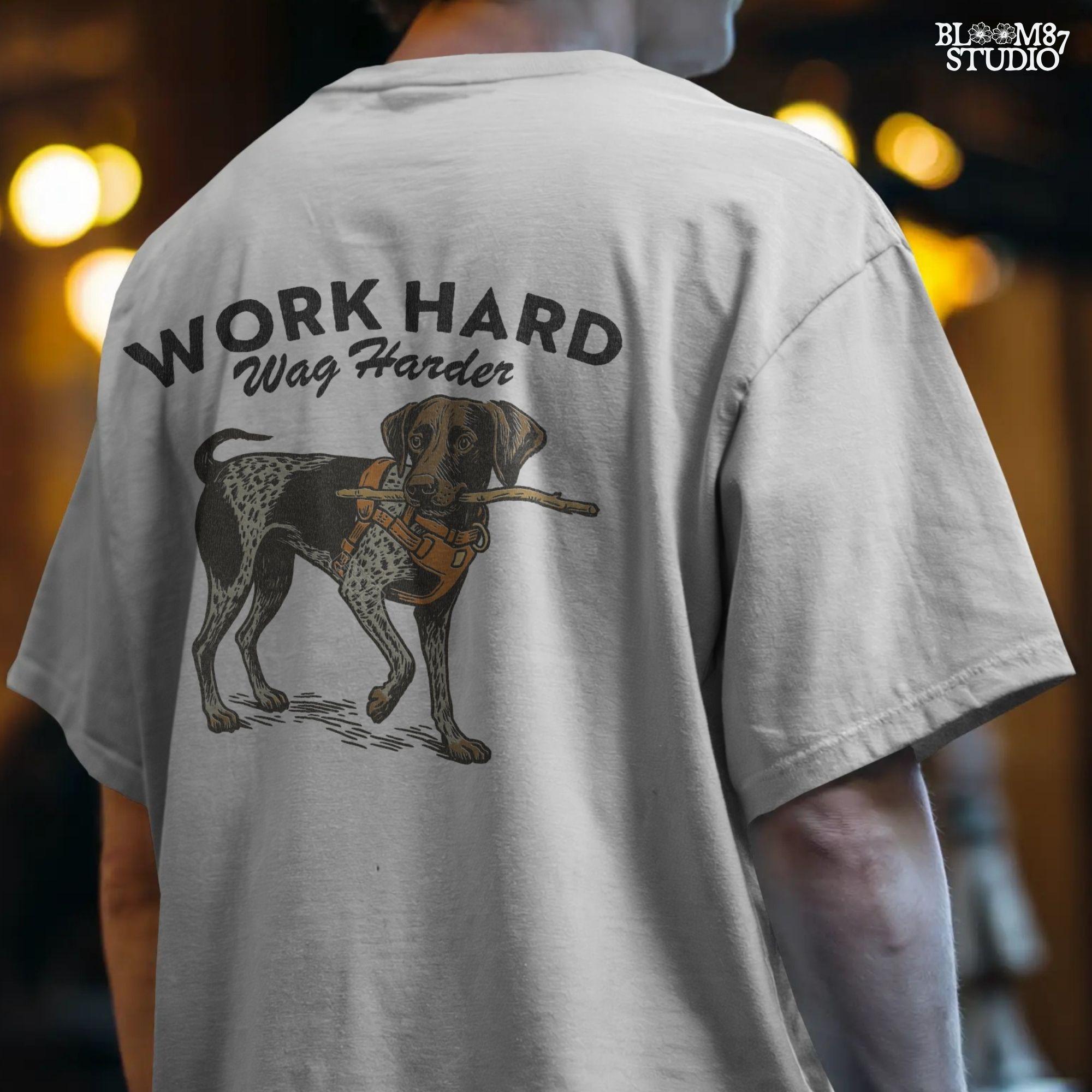 German Shorthaired Pointer dog wearing orange harness holding a stick with text “Work Hard Wag Harder” above, PNG design for sublimation use