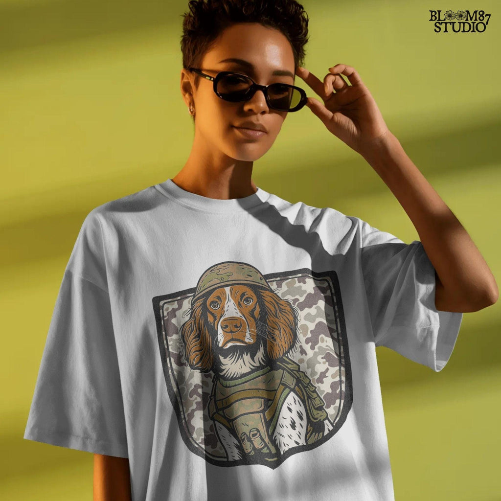 Illustration of a military hunting dog in camo vest and helmet, standing in front of a camouflage shield background, PNG for sublimation use