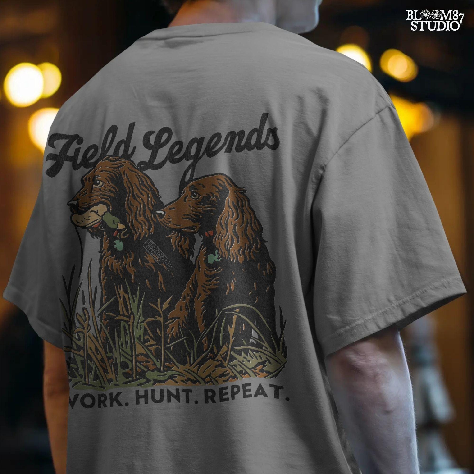 Vintage-style illustration of two retriever hunting dogs sitting in tall grass with text “Field Legends” and “Work. Hunt. Repeat.” – PNG for sublimation use
