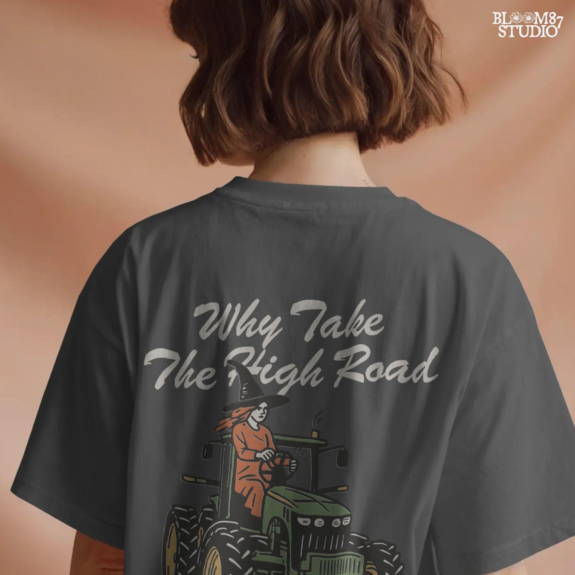 Funny illustration of a red-haired witch in a black hat driving a green tractor with the quote “Why take the high road when you can take the psycho path,” in rustic cartoon style.