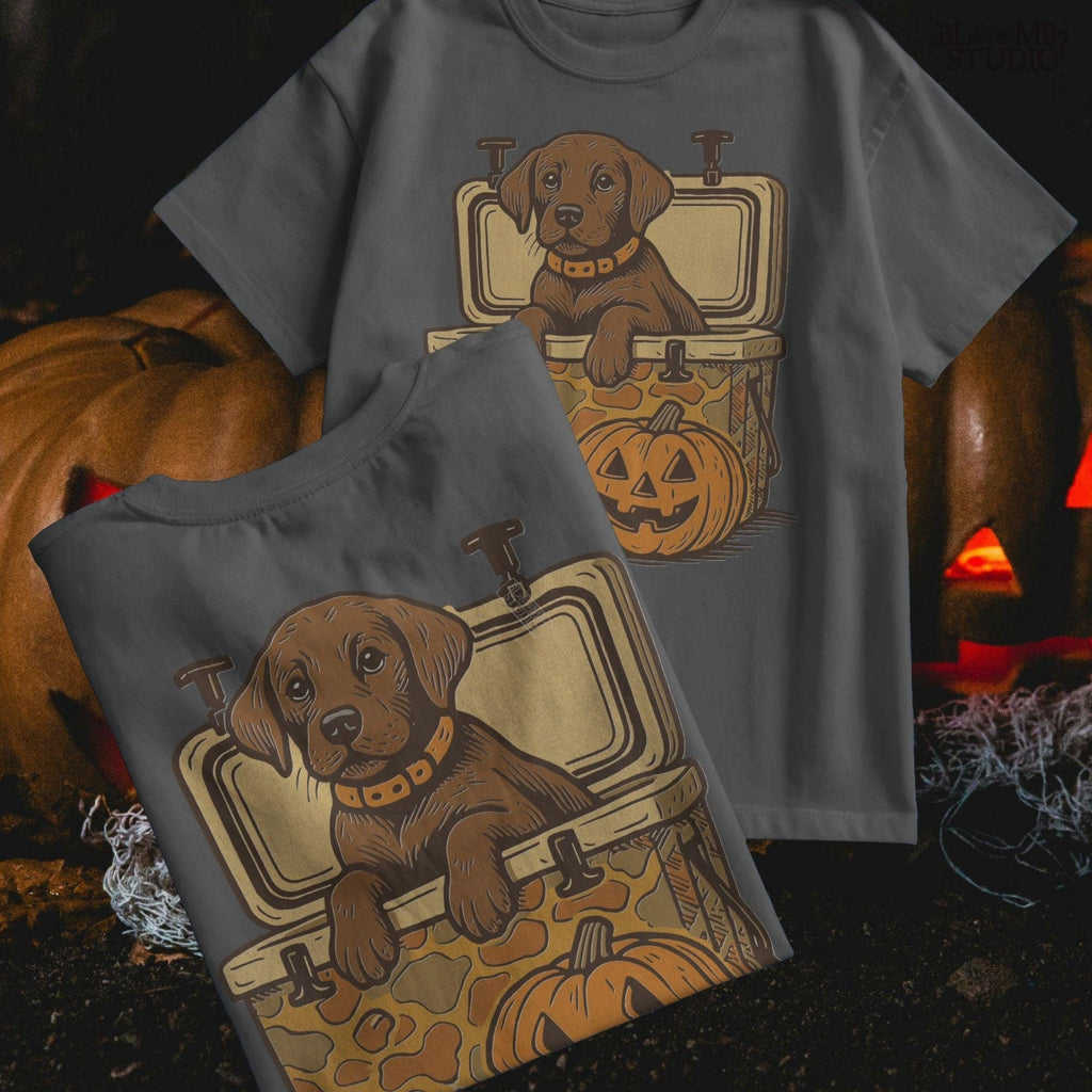 Cute brown hunting dog in a camo cooler next to a carved pumpkin, Halloween-themed sublimation PNG for fall shirts or seasonal crafts.