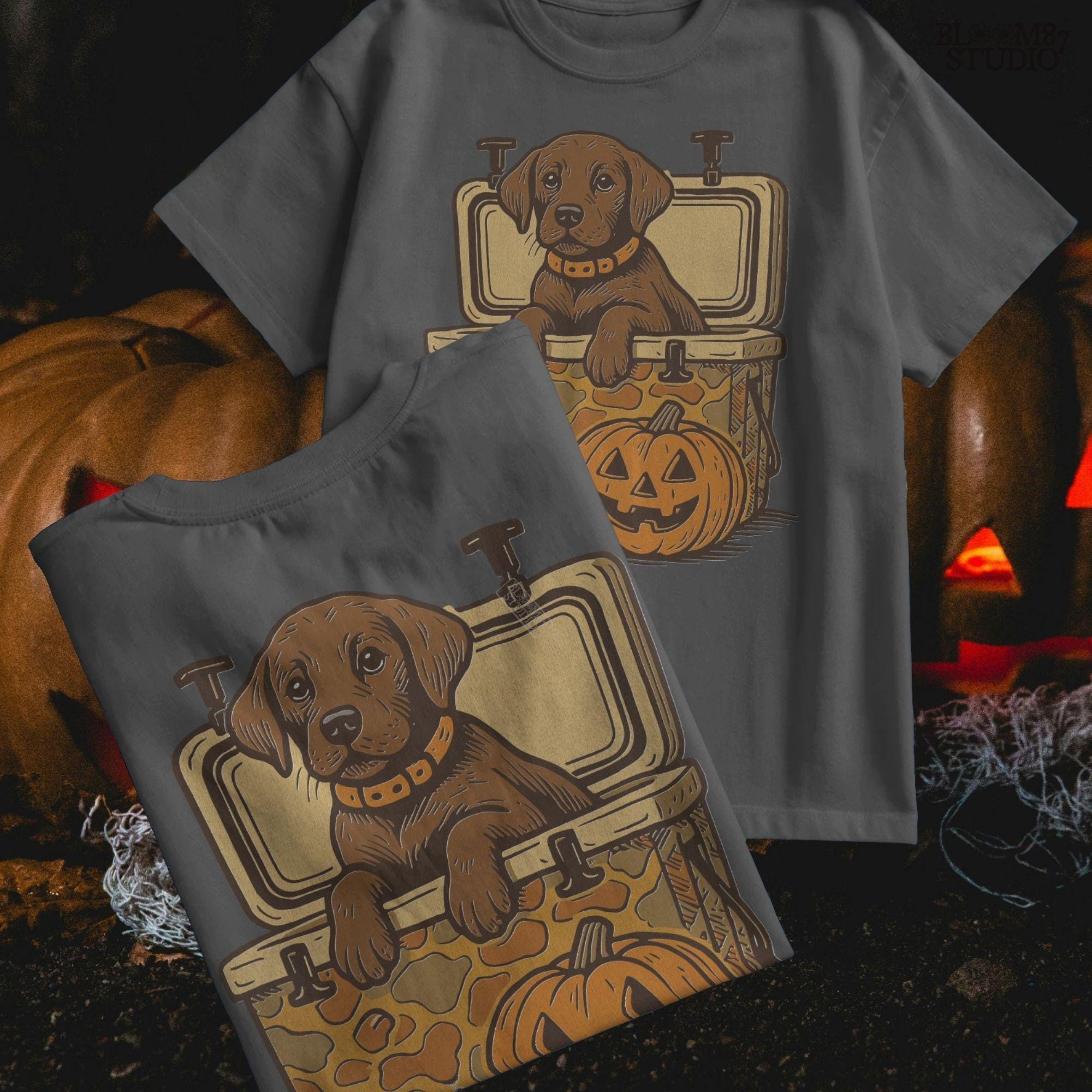Cute brown hunting dog in a camo cooler next to a carved pumpkin, Halloween-themed sublimation PNG for fall shirts or seasonal crafts.