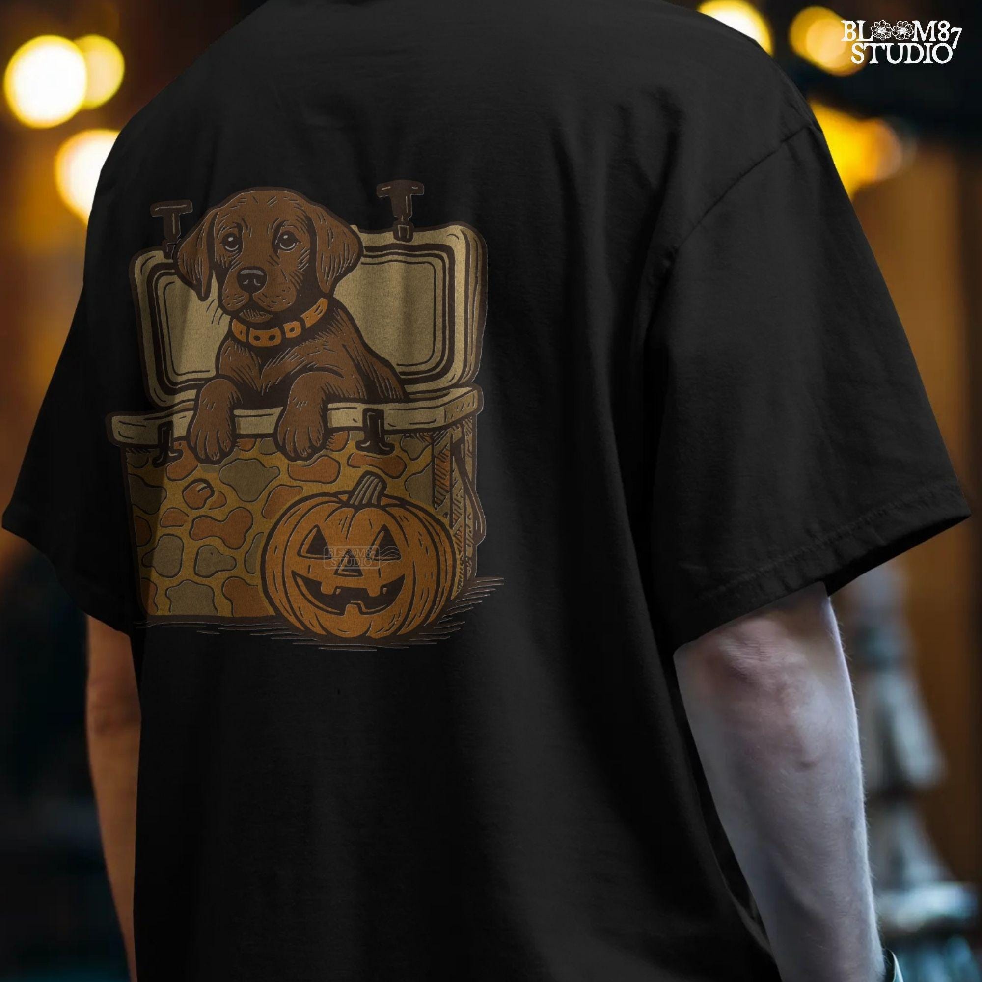 Cute brown hunting dog in a camo cooler next to a carved pumpkin, Halloween-themed sublimation PNG for fall shirts or seasonal crafts.