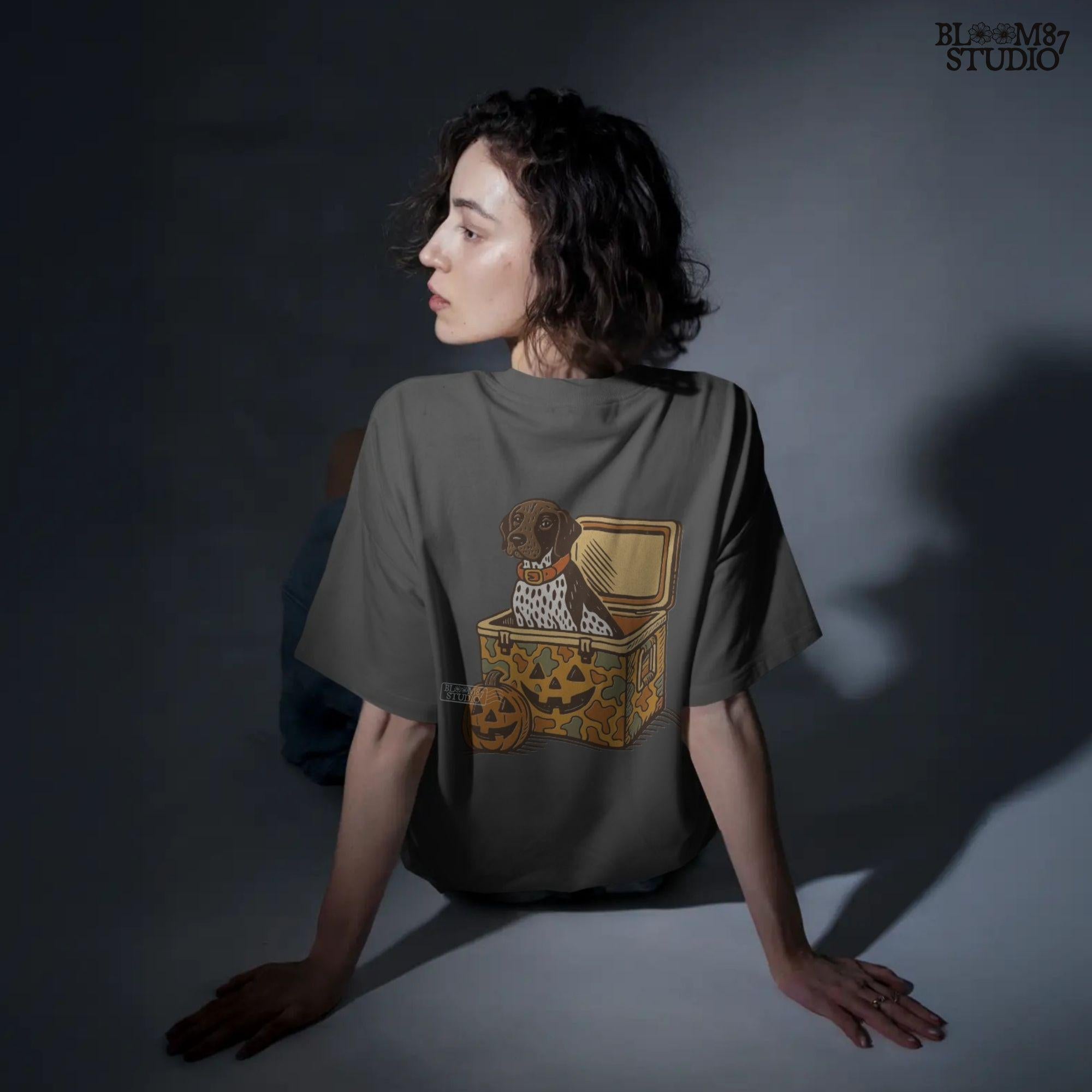 German Shorthair Pointer dog sitting inside a camo cooler with Jack O’ Lantern carvings, Halloween-themed sublimation PNG for fall shirts.