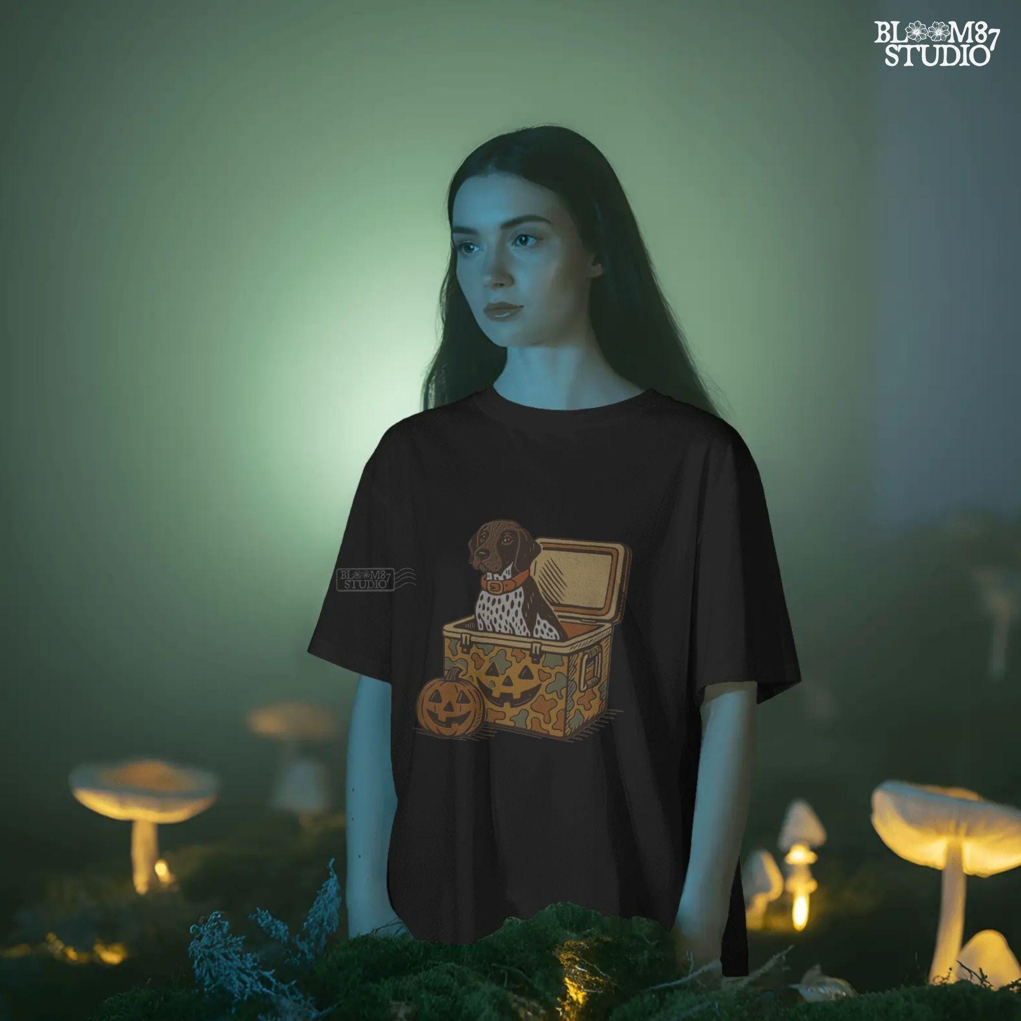 German Shorthair Pointer dog sitting inside a camo cooler with Jack O’ Lantern carvings, Halloween-themed sublimation PNG for fall shirts.