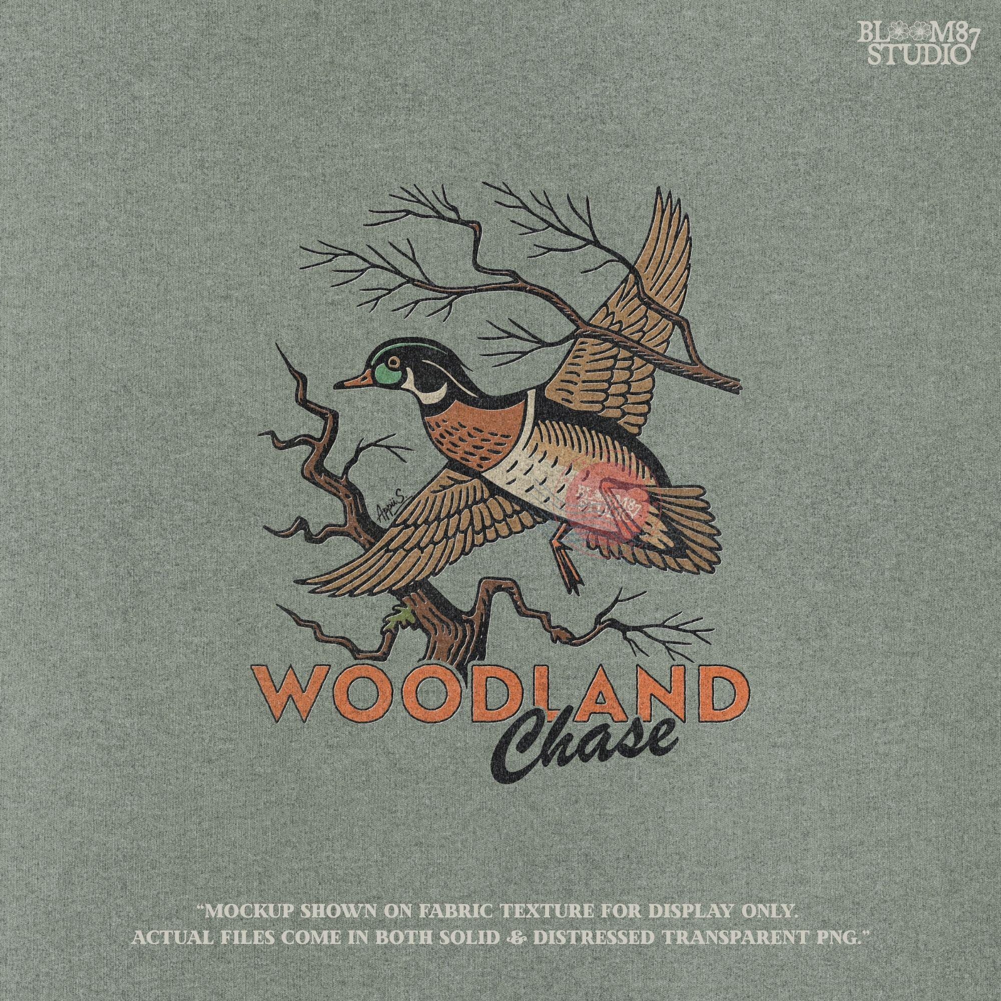 Vintage wood duck flying over bare branches with “Woodland Chase” text in rustic orange and black; sublimation PNG for hunting or fall apparel.