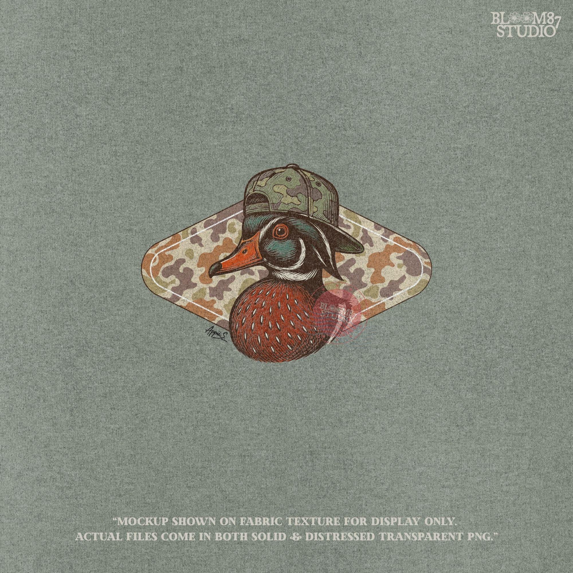Illustration of a wood duck with a camouflage hat, placed over a brown woodland camo background, styled for fall hunting and Thanksgiving crafts.