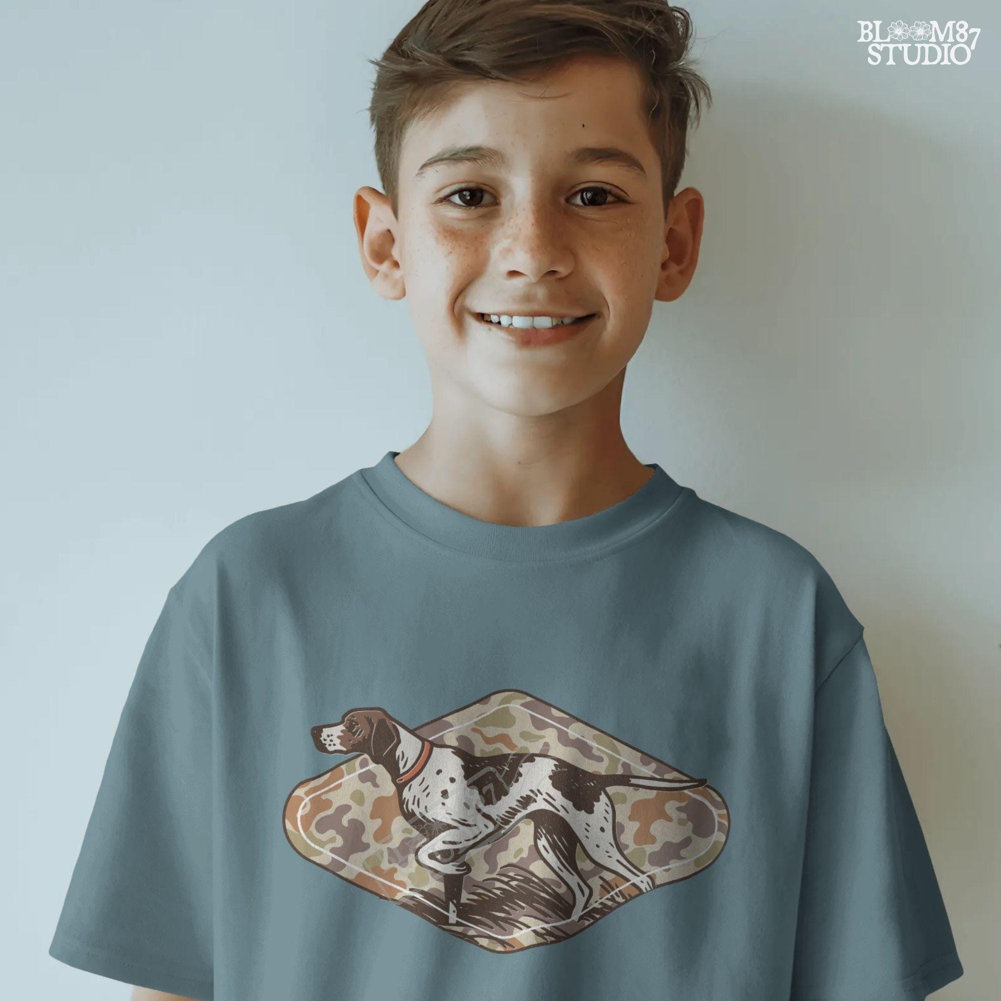 Brown and white hunting pointer dog in a standing pose over a woodland camo background, perfect for fall or Thanksgiving-themed sublimation designs.