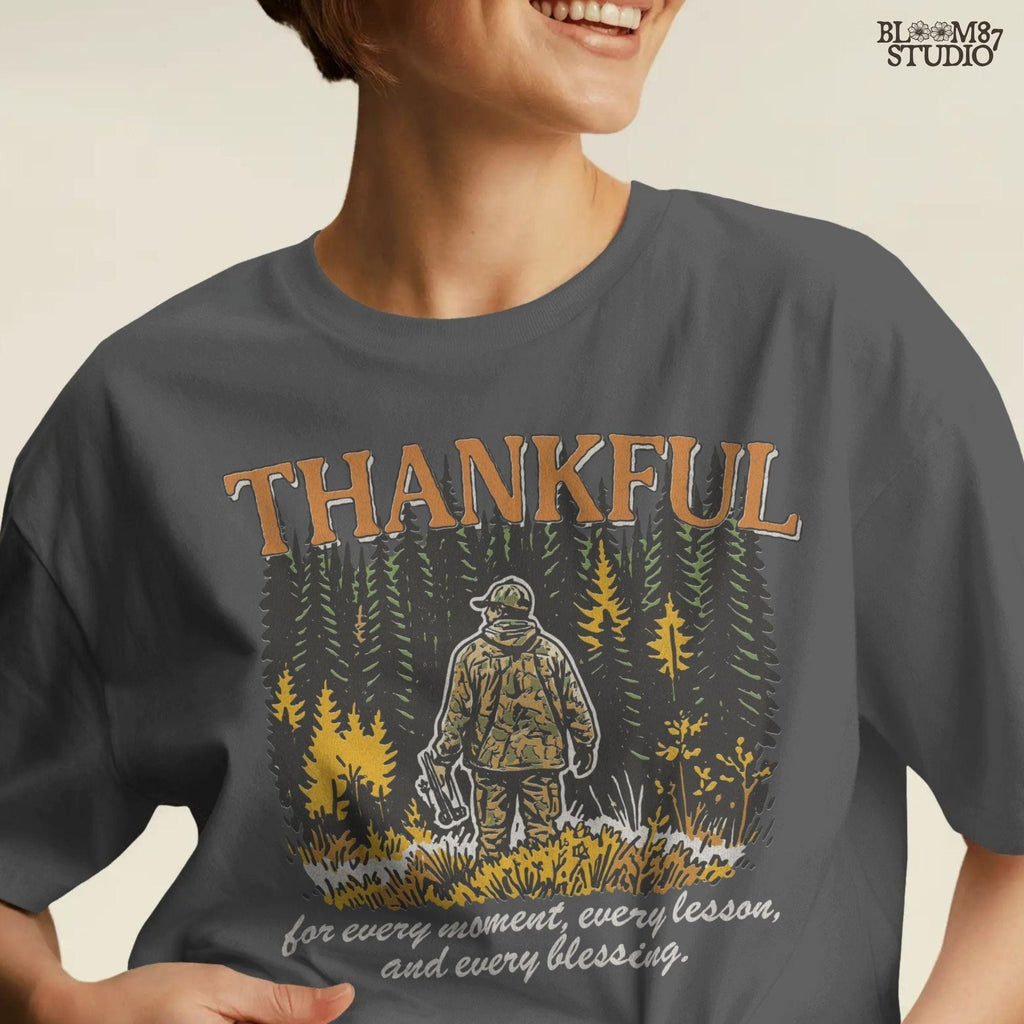 Illustration of a hunter in camo standing in a fall forest with the word “THANKFUL” above and a quote below, designed for sublimation projects.